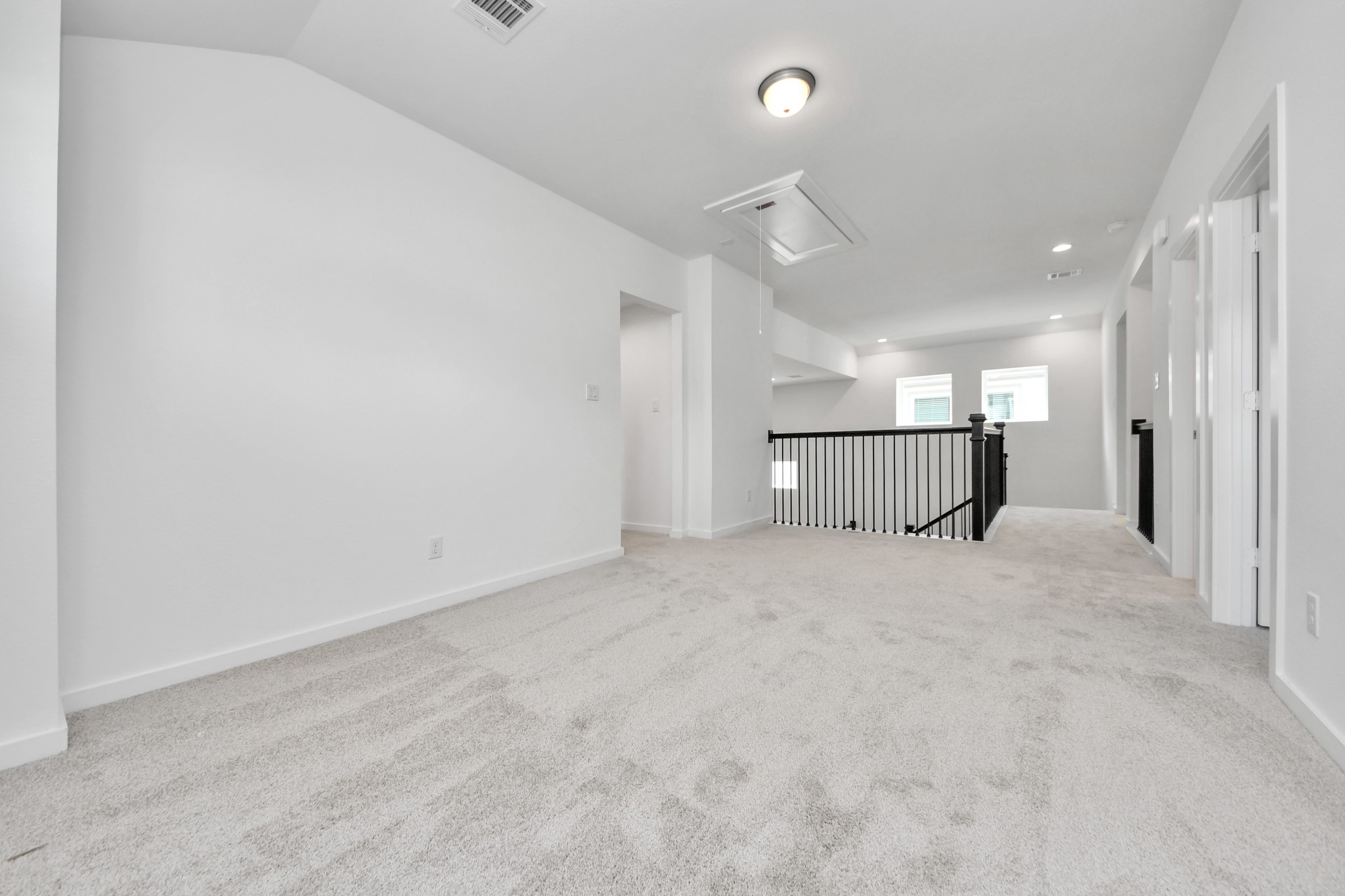 Come upstairs and enjoy a day of leisure in this fabulous game room! This is the perfect hangout spot or adult game room! Features plush carpet, high ceilings, custom paint and windows for plenty of natural light. Sample photo of completed home with similar floor plan. Actual colors and selections may vary.