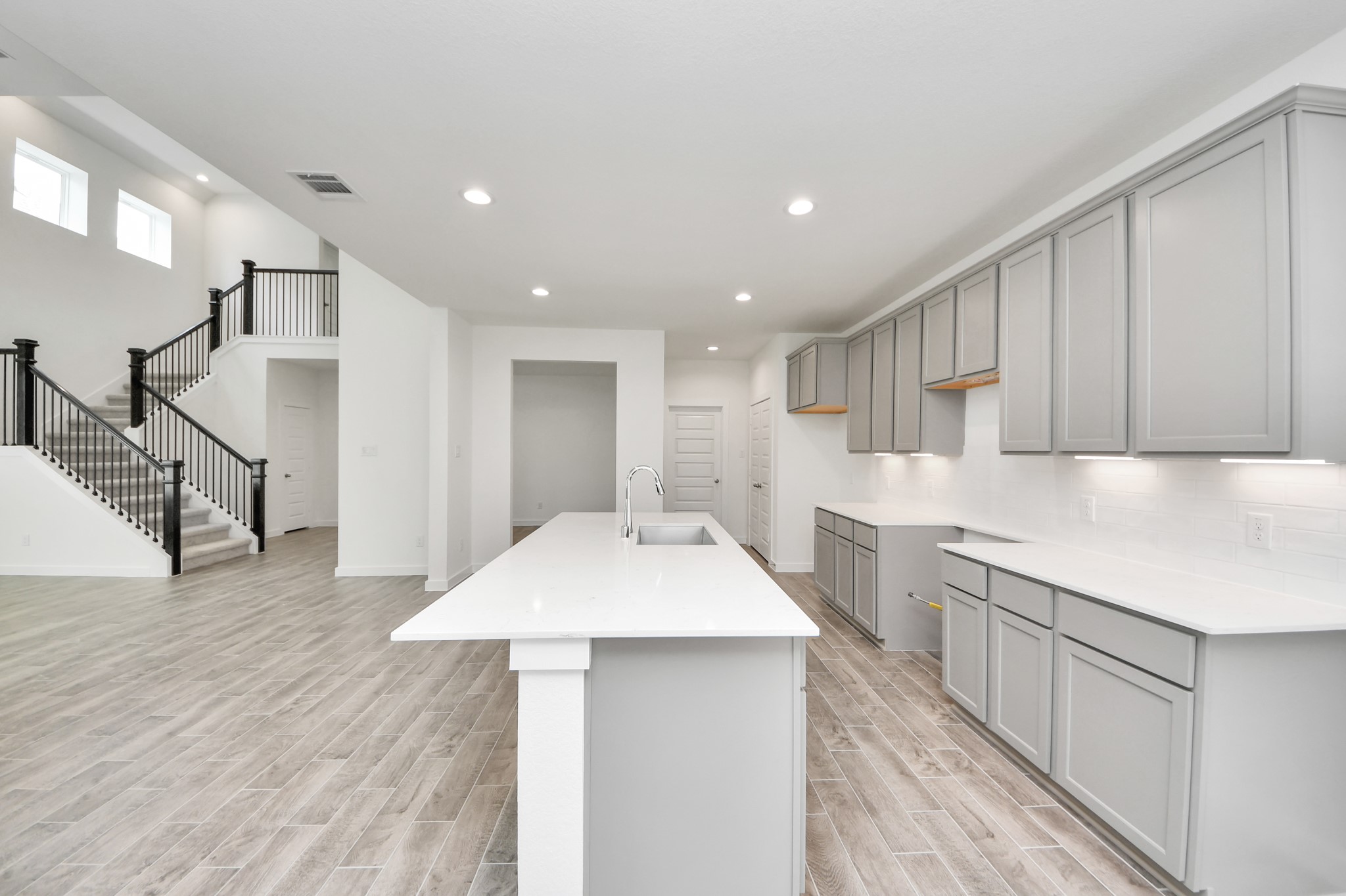 The open concept effortlessly connects the kitchen to the expansive family room, forming a perfect hub for gatherings. This seamless flow creates an inviting space where cooking and socializing come together harmoniously. Sample photo of completed home with similar floor plan. Actual colors and selections may vary.