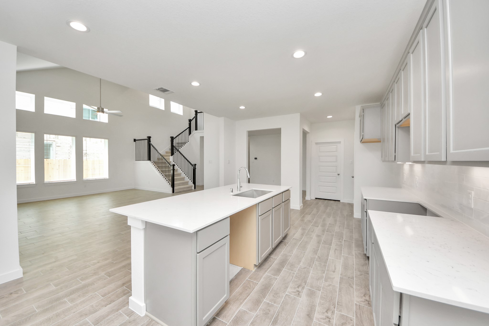 All of this overlooks your expansive family room, creating a perfect space for culinary delights and family gatherings. Sample photo of completed home with similar floor plan. Actual colors and selections may vary.