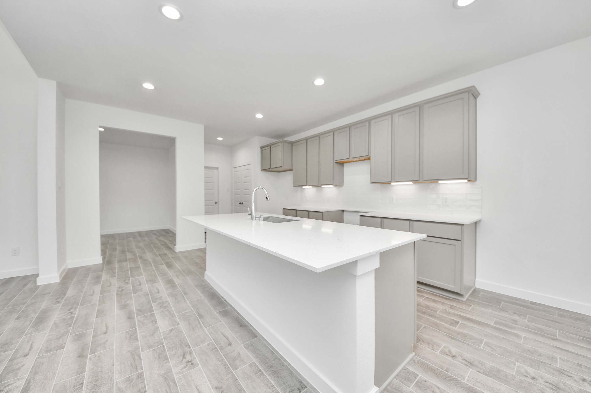 The extended counter area adds both practicality and style, making meal preparation a breeze. Every detail is thoughtfully designed to enhance the kitchen's functionality and aesthetic appeal. Sample photo of completed home with similar floor plan. Actual colors and selections may vary.