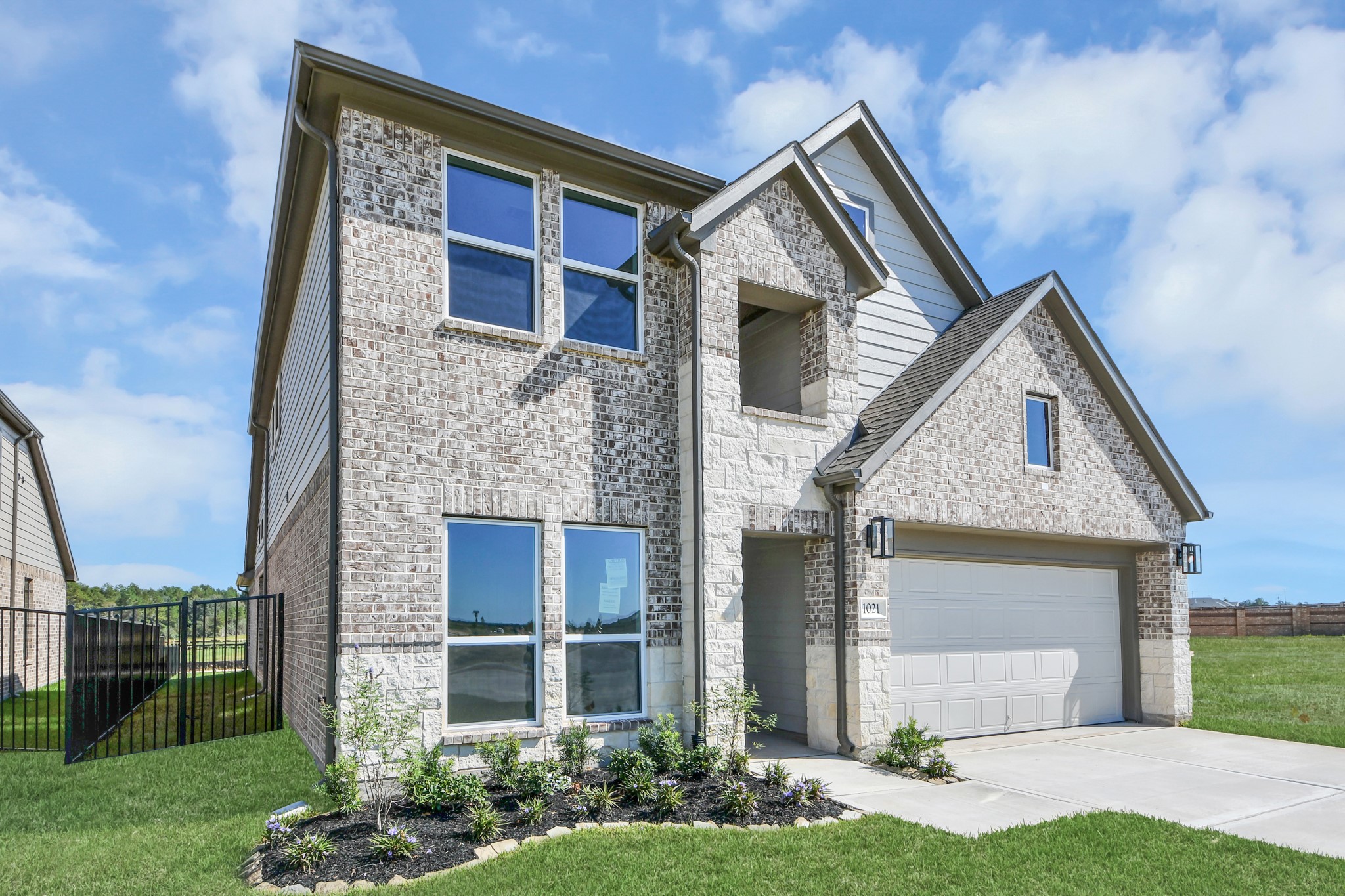 The residence features a practical 2-car garage complemented by a generous driveway, ensuring abundant space for parking needs. The residence features a practical 2-car garage complemented by a generous driveway, ensuring abundant space for parking needs.