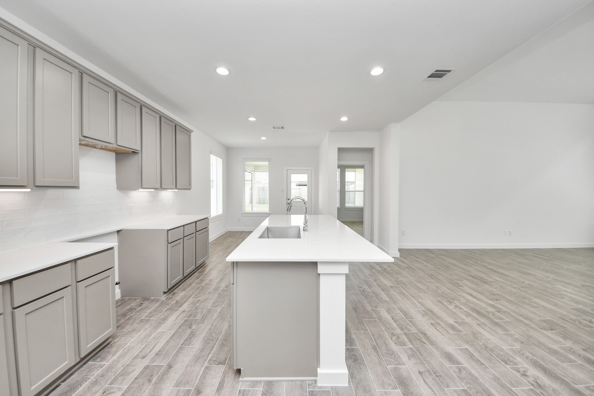 This kitchen is by far any chefs dream! This spacious kitchen features high ceilings, light stained wood cabinets, granite countertop, SS appliances, modern tile backsplash, recessed lighting, extended counter space, granite kitchen island with double sink, and space for breakfast bar, and a walk-in pantry all overlooking your huge family room. Sample photo of completed home with similar floor plan. Actual colors and selections may vary. This kitchen is by far any chefs dream! This spacious kitchen features high ceilings, light stained wood cabinets, granite countertop, SS appliances, modern tile backsplash, recessed lighting, extended counter space, granite kitchen island with double sink, and space for breakfast bar, and a walk-in pantry all overlooking your huge family room. Sample photo of completed home with similar floor plan. Actual colors and selections may vary.