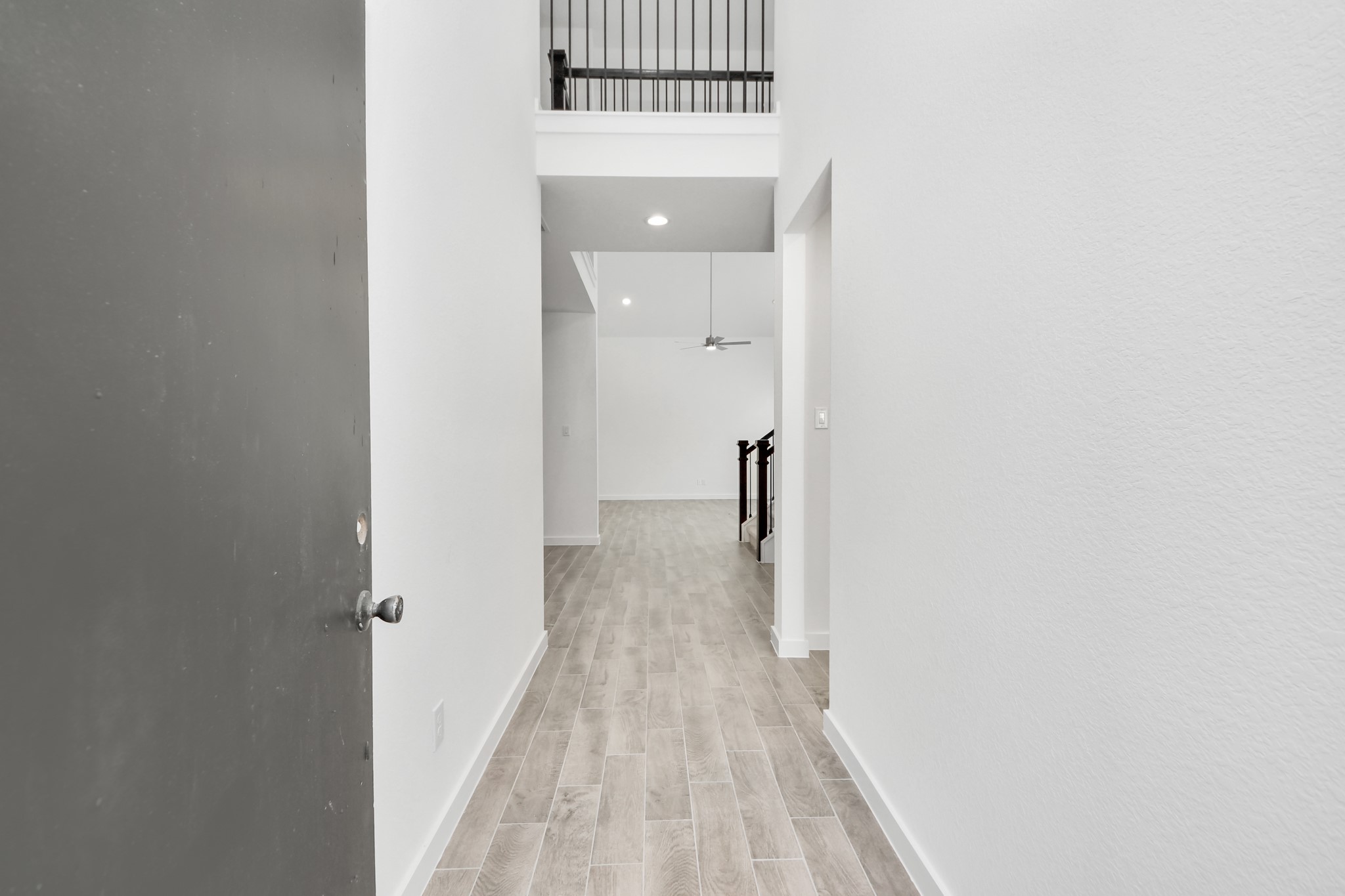 As you step into the threshold of this luxurious home, you'll soon be welcomed by an elegant glass door (to be installed). Inside, soaring ceilings amplify the spaciousness, while the refined wood-look tile flooring and oversized baseboards exude sophistication and charm. Sample photo of completed home with similar floor plan. Actual colors and selections may vary. As you step into the threshold of this luxurious home, you'll soon be welcomed by an elegant glass door (to be installed). Inside, soaring ceilings amplify the spaciousness, while the refined wood-look tile flooring and oversized baseboards exude sophistication and charm. Sample photo of completed home with similar floor plan. Actual colors and selections may vary.