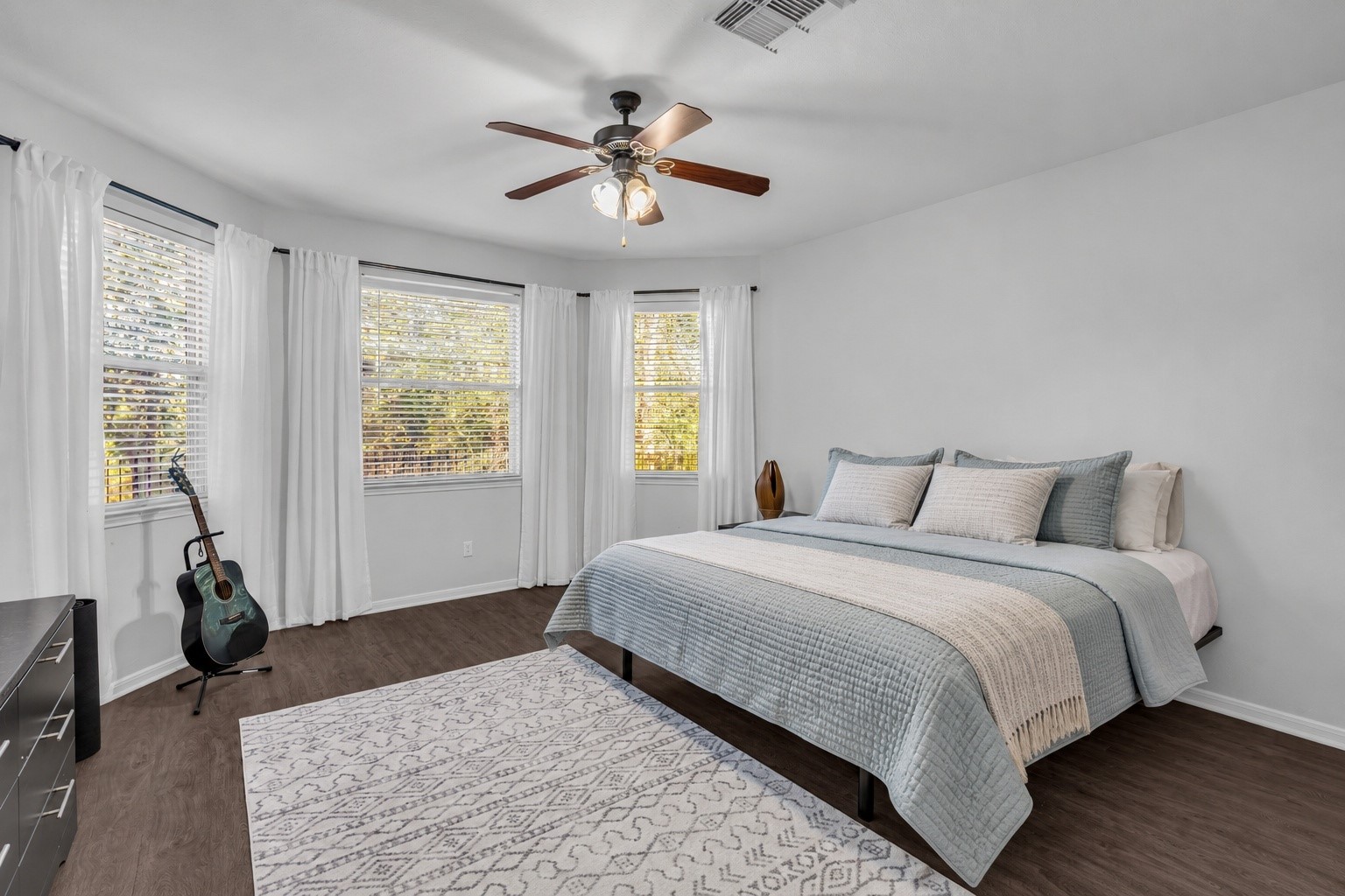 Welcome to your primary bedroom.Spacious and a wall of windows to the nature preserve behind the home