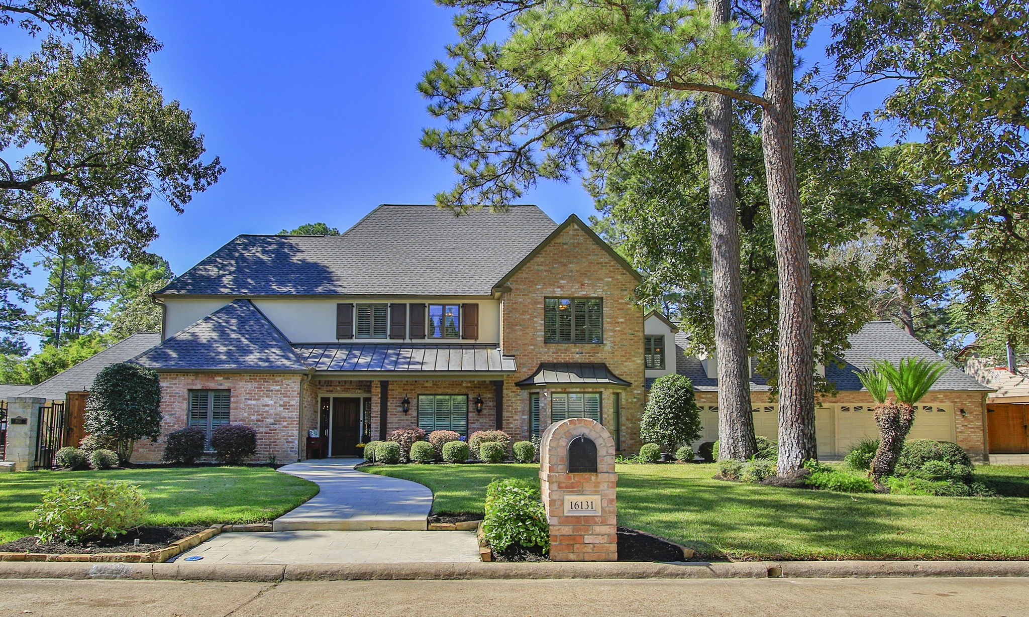 Stunning traditional home in the heart of Champion Forest - with timeless curb appeal, beautiful brick architecture, elegant rooflines, and a welcoming covered front porch. Stunning traditional home in the heart of Champion Forest - with timeless curb appeal, beautiful brick architecture, elegant rooflines, and a welcoming covered front porch.