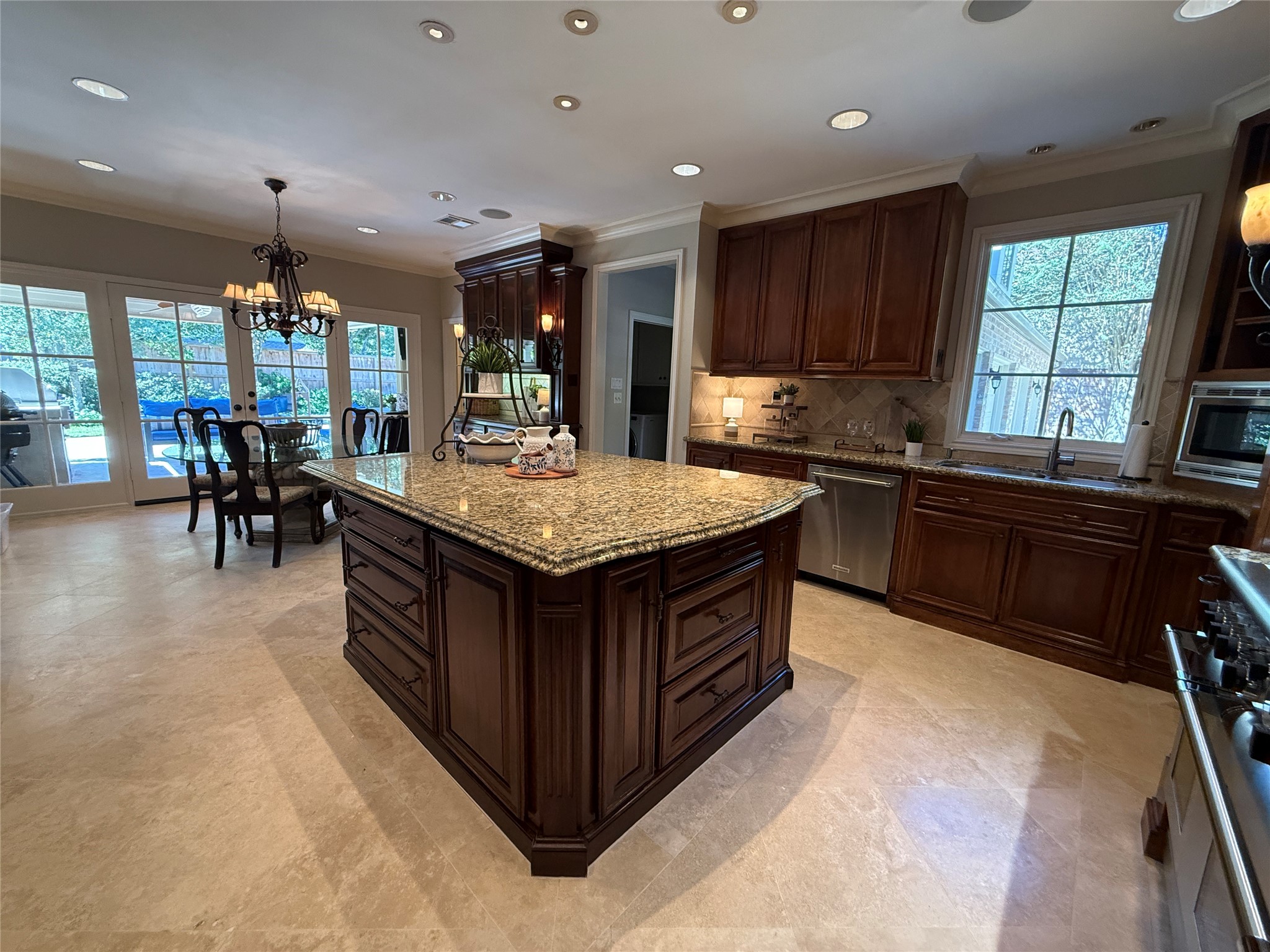 View of the breakfast room, built in lighted cabinet and door to the powder bath.