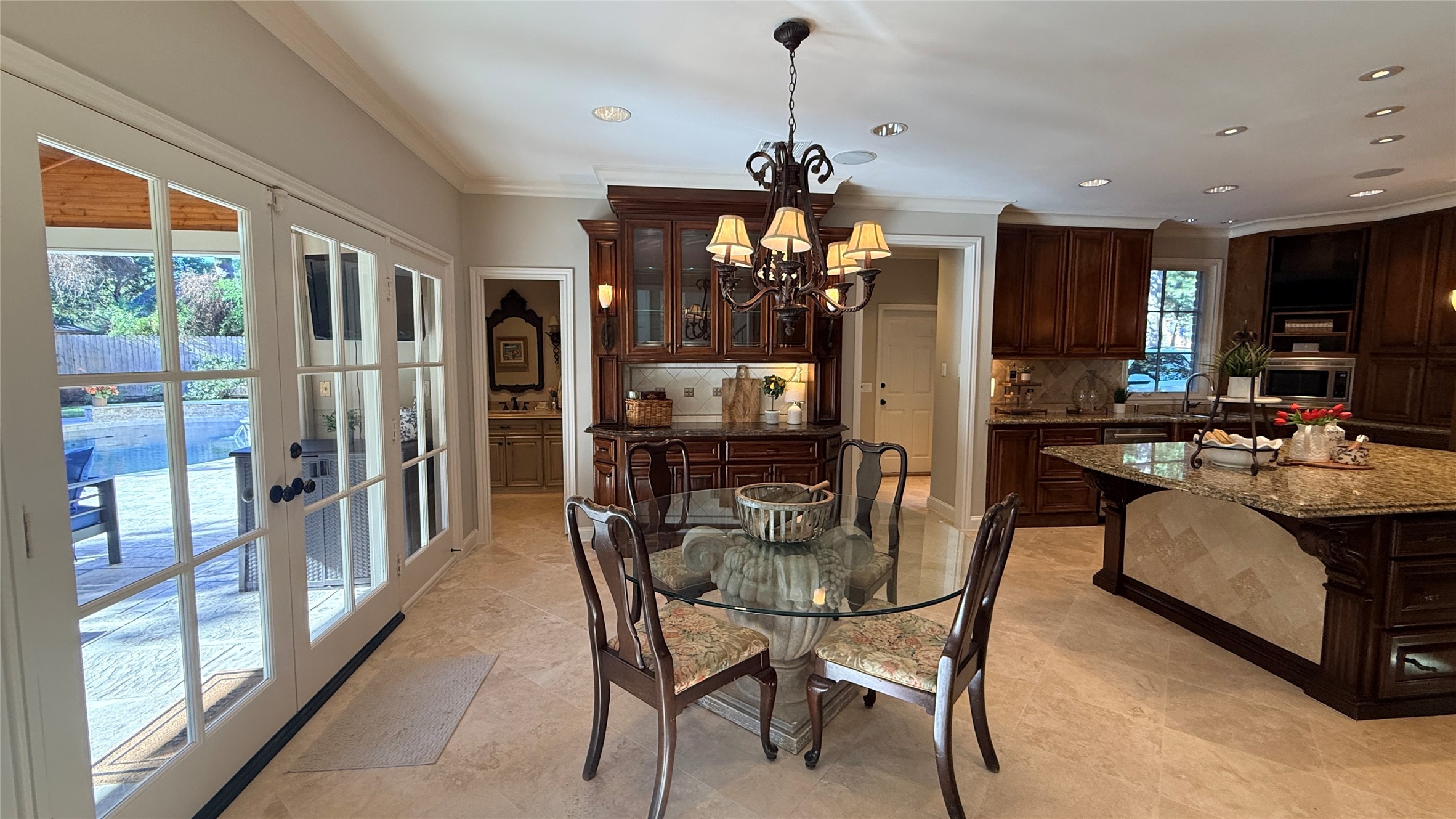 View of the breakfast room, built in lighted cabinet and door to the powder bath.