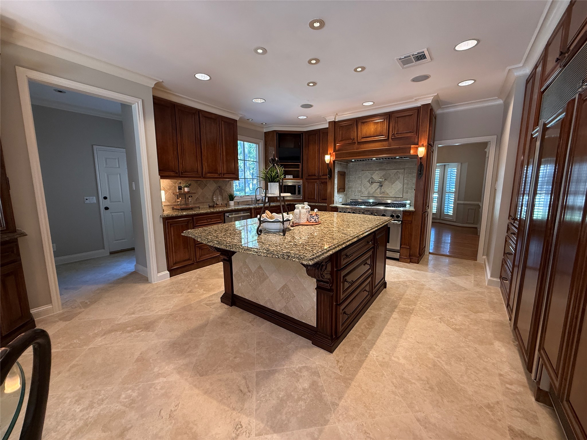 Stunning kitchen with large granite island and Thermador range.