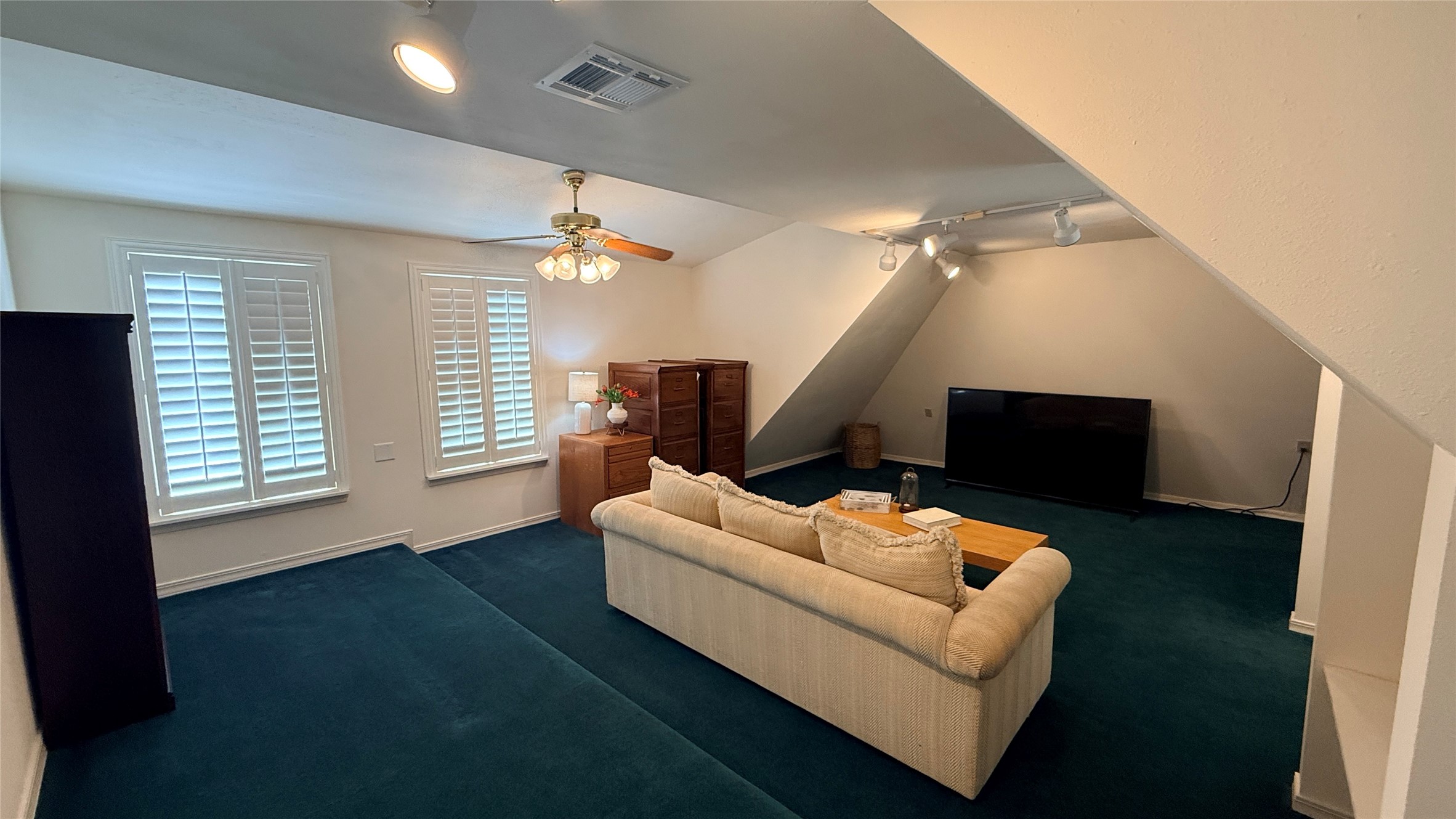 Media room/Flex room with windows on the front and back of the house.