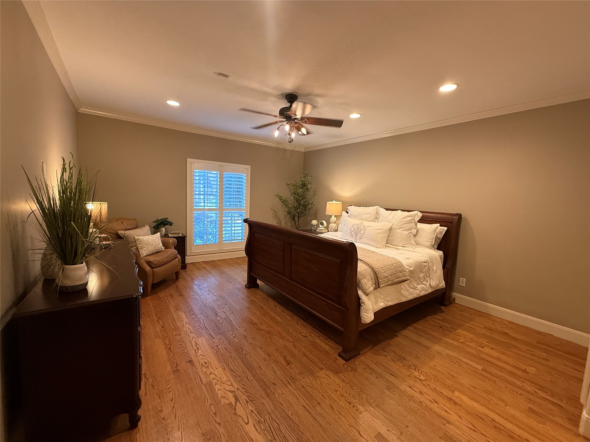 Primary bedroom with plantation shutters.
