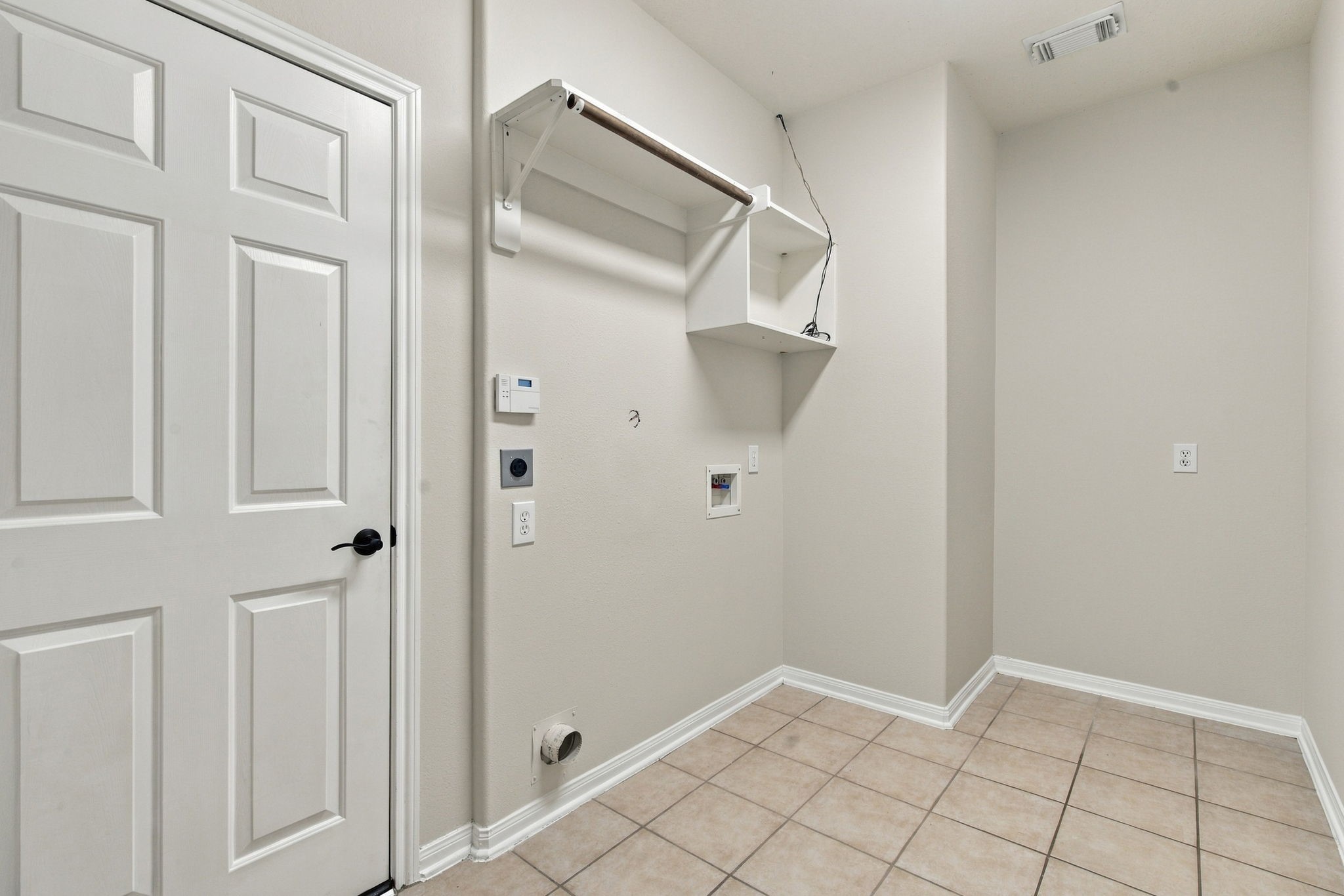 View of the laundry room with access to the garage.