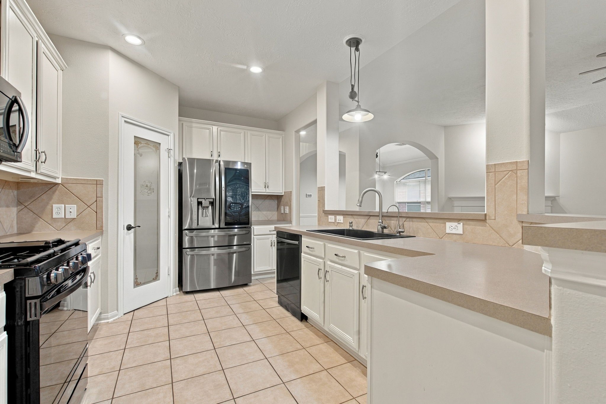 Amazing kitchen offers a stone kitchen sink, ample breakfast bar seating, and a walk-in pantry!