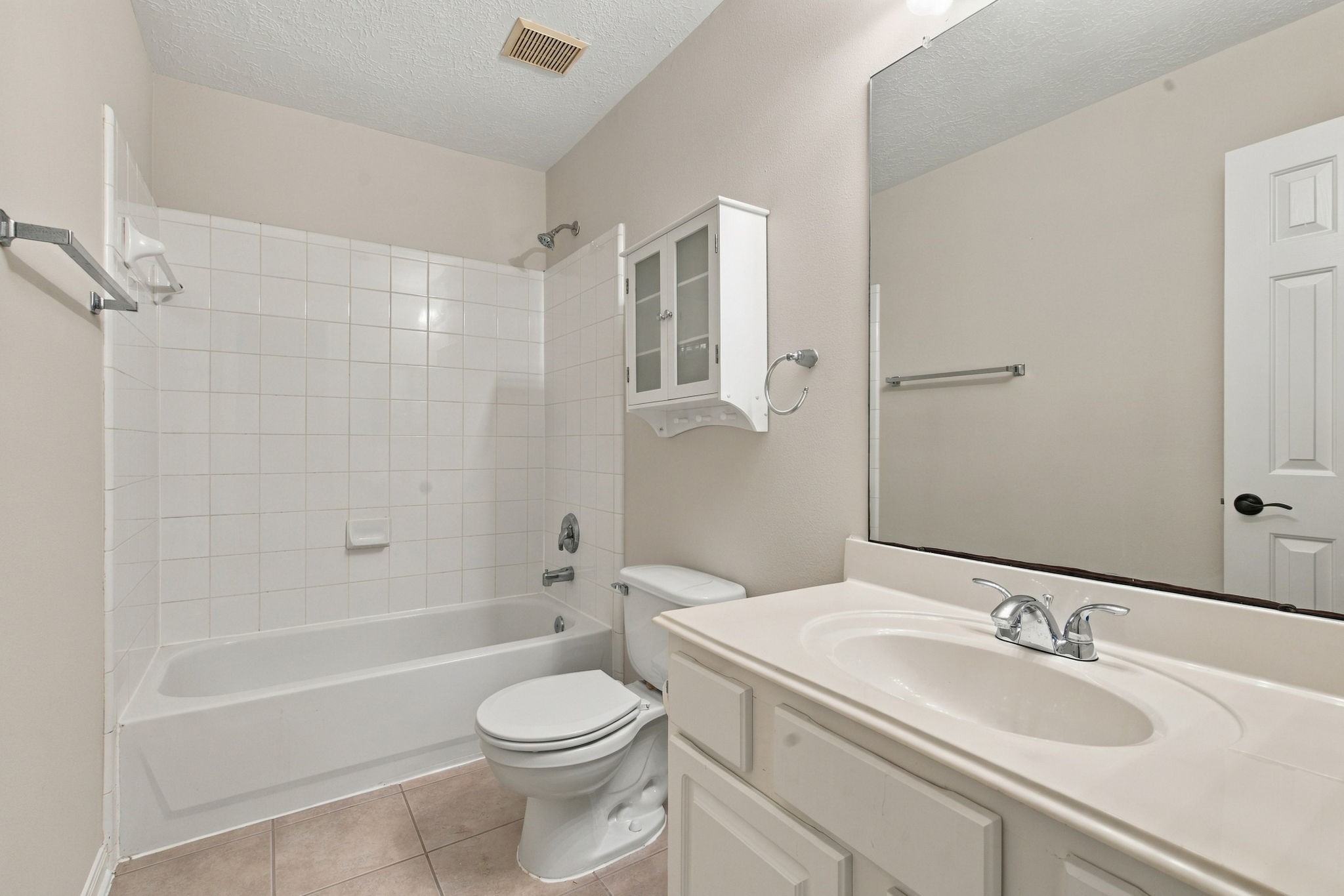 View of the upstairs bathroom with a combination tub and shower.