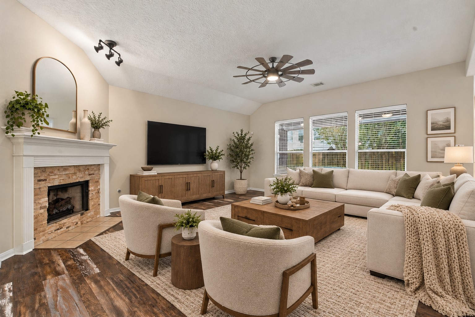 Spacious living room with a cozy fireplace and overlooks the backyard. (Virtually Staged)