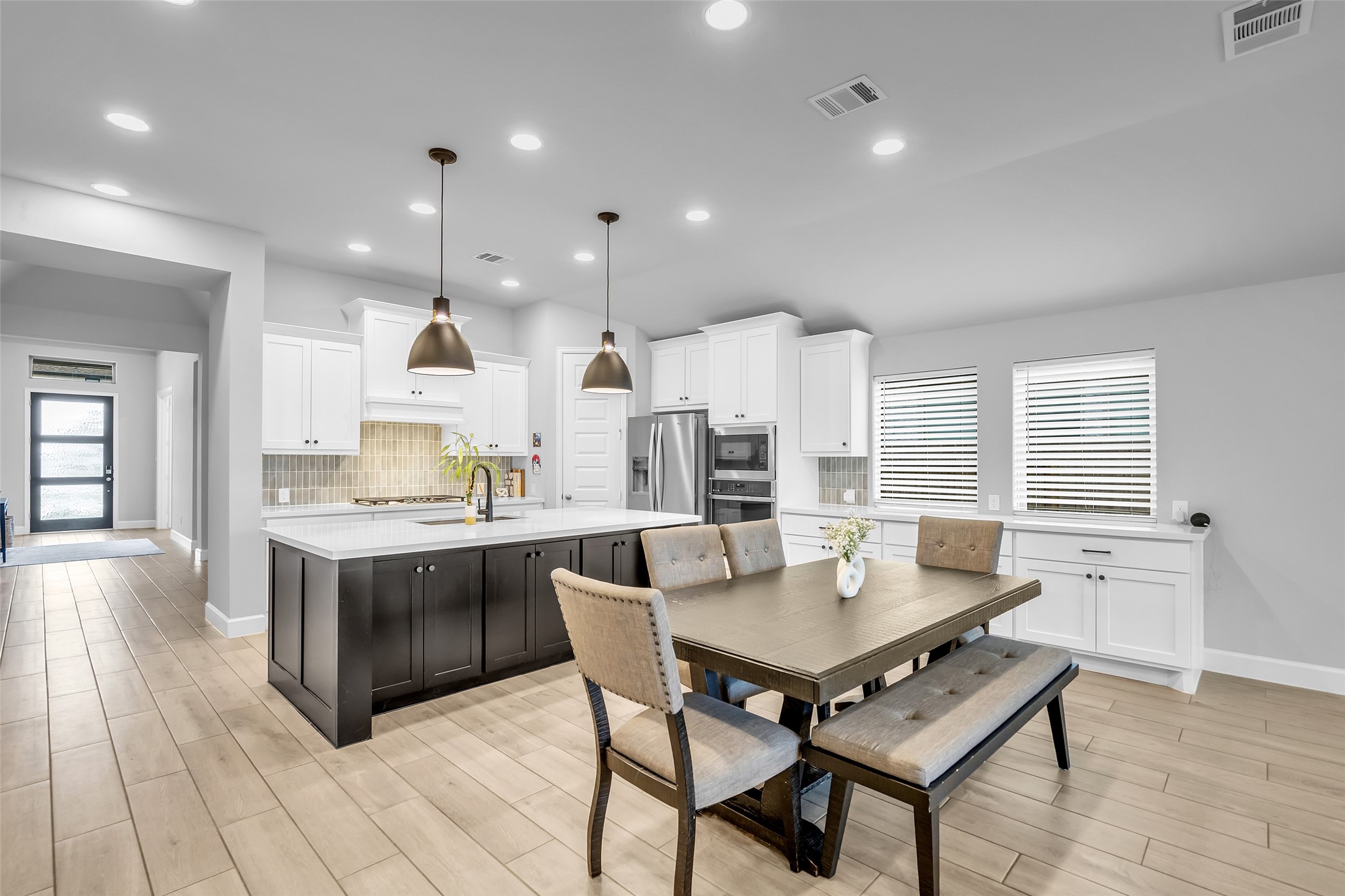 Your Lovely Kitchen Features Breakfast Bar w/ Under Cabinet Storage, Long Buffet, & Plenty of Lighting to Brighten Your Home.