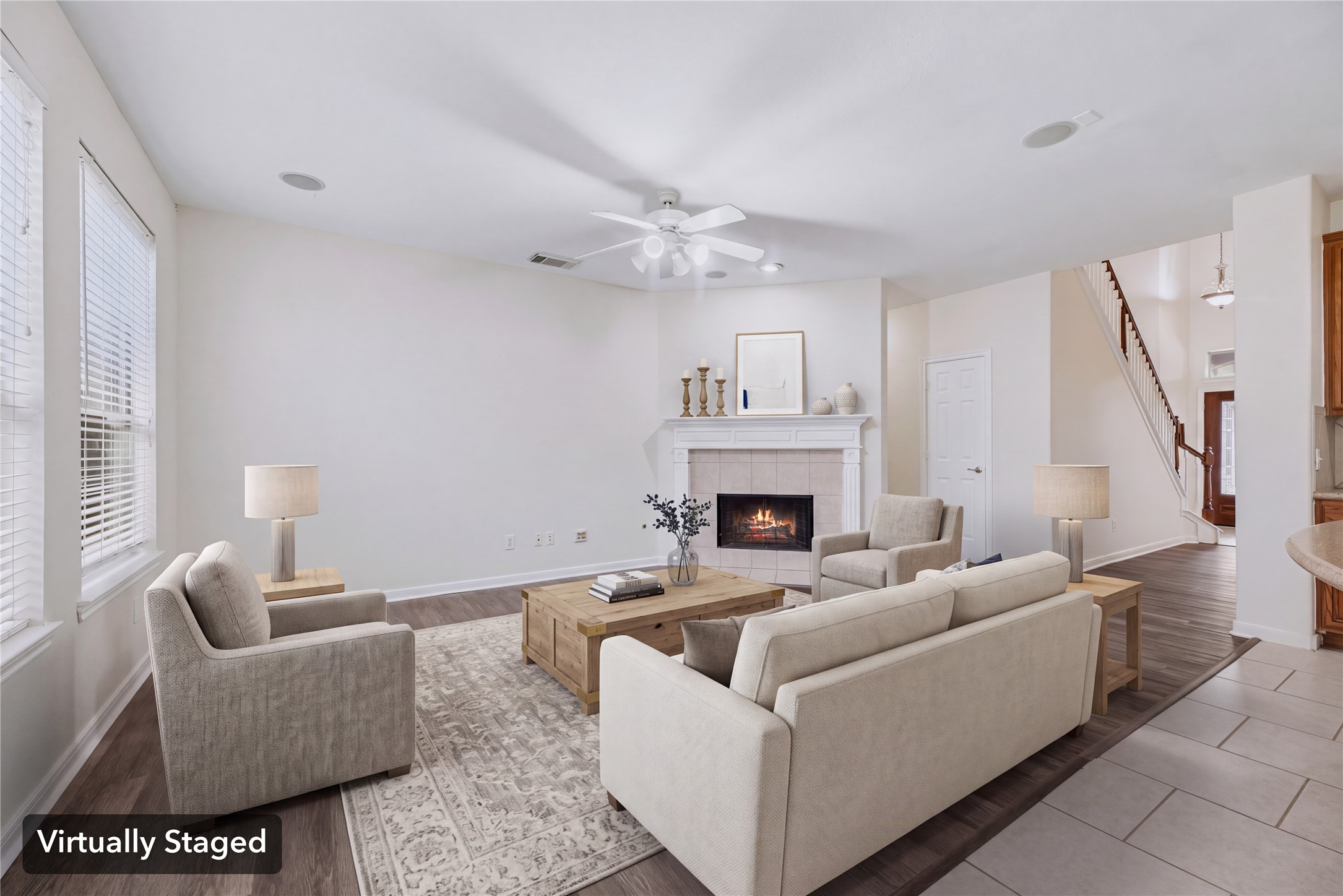 Virtually staged to show a conversation-friendly seating layout and the open path toward the kitchen and entry. Furniture shown is digital.