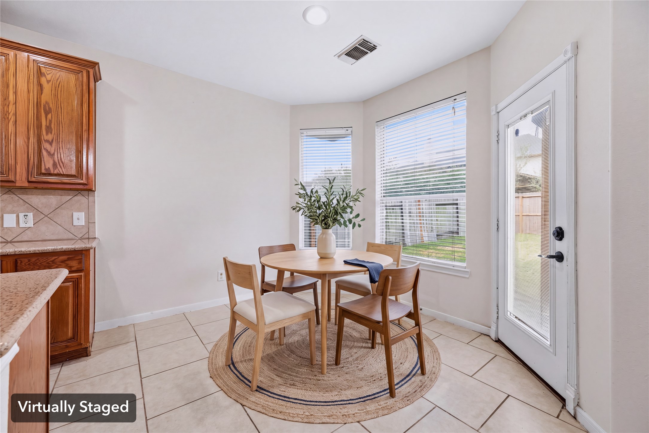 Virtually staged to show a breakfast table beside the rear windows, with the backyard door within easy reach. Furniture shown is digital.