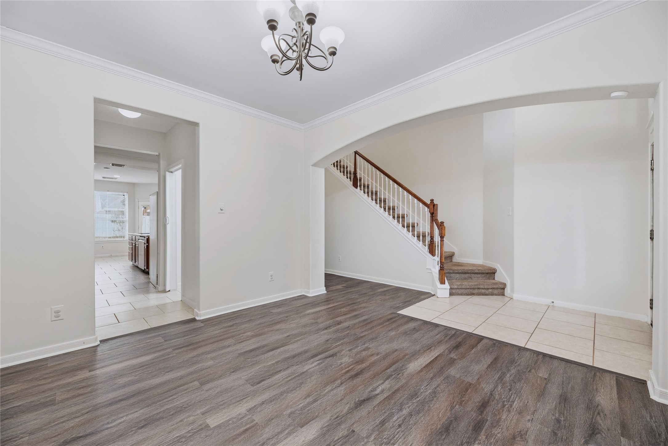 This unfurnished view shows the front living area and its open connection to the entry, giving you a clear look at the layout before planning your furniture. This unfurnished view shows the front living area and its open connection to the entry, giving you a clear look at the layout before planning your furniture.