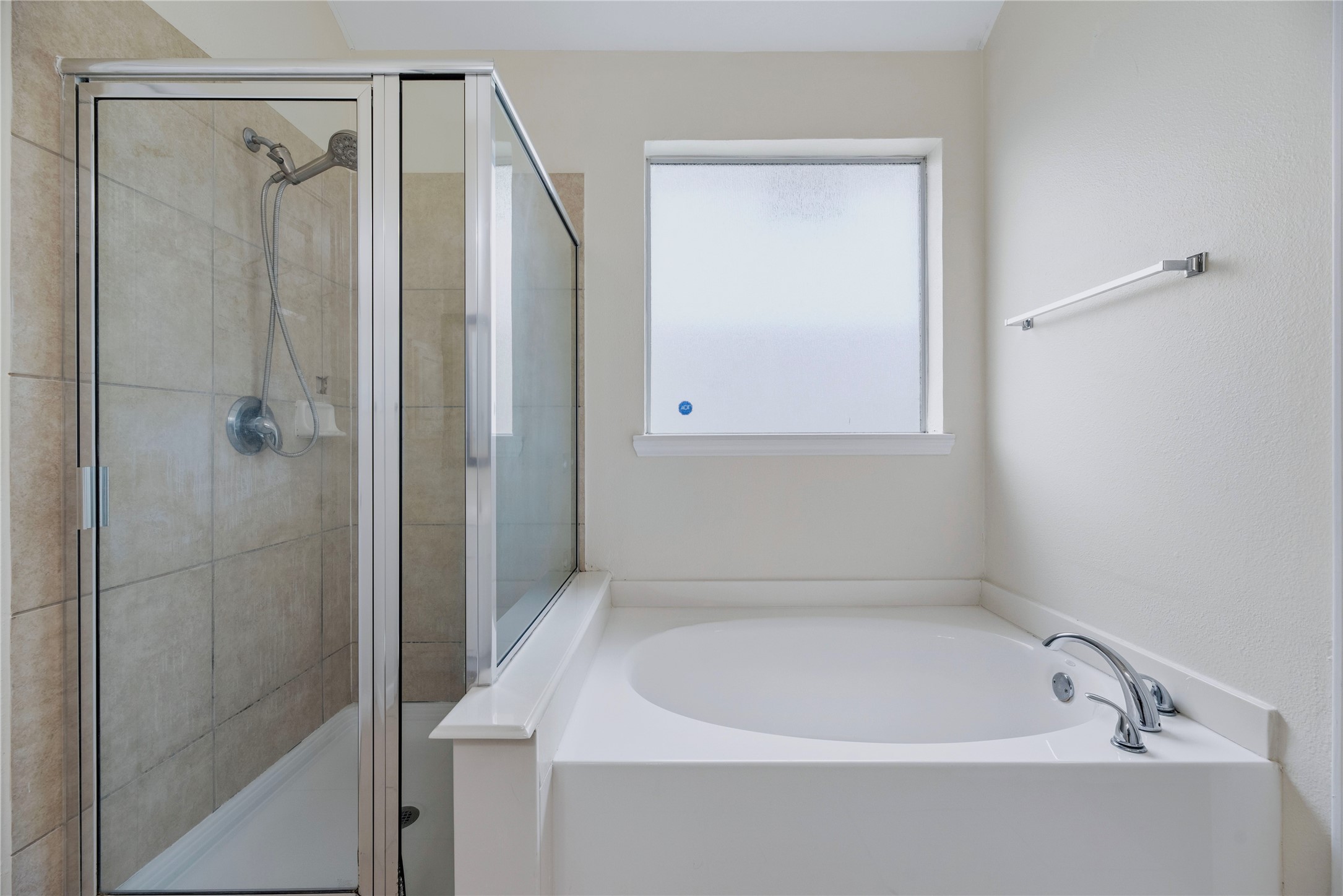 The primary bath offers a separate tub and enclosed shower, giving you a choice for the daily routine without combining both into one fixture.
