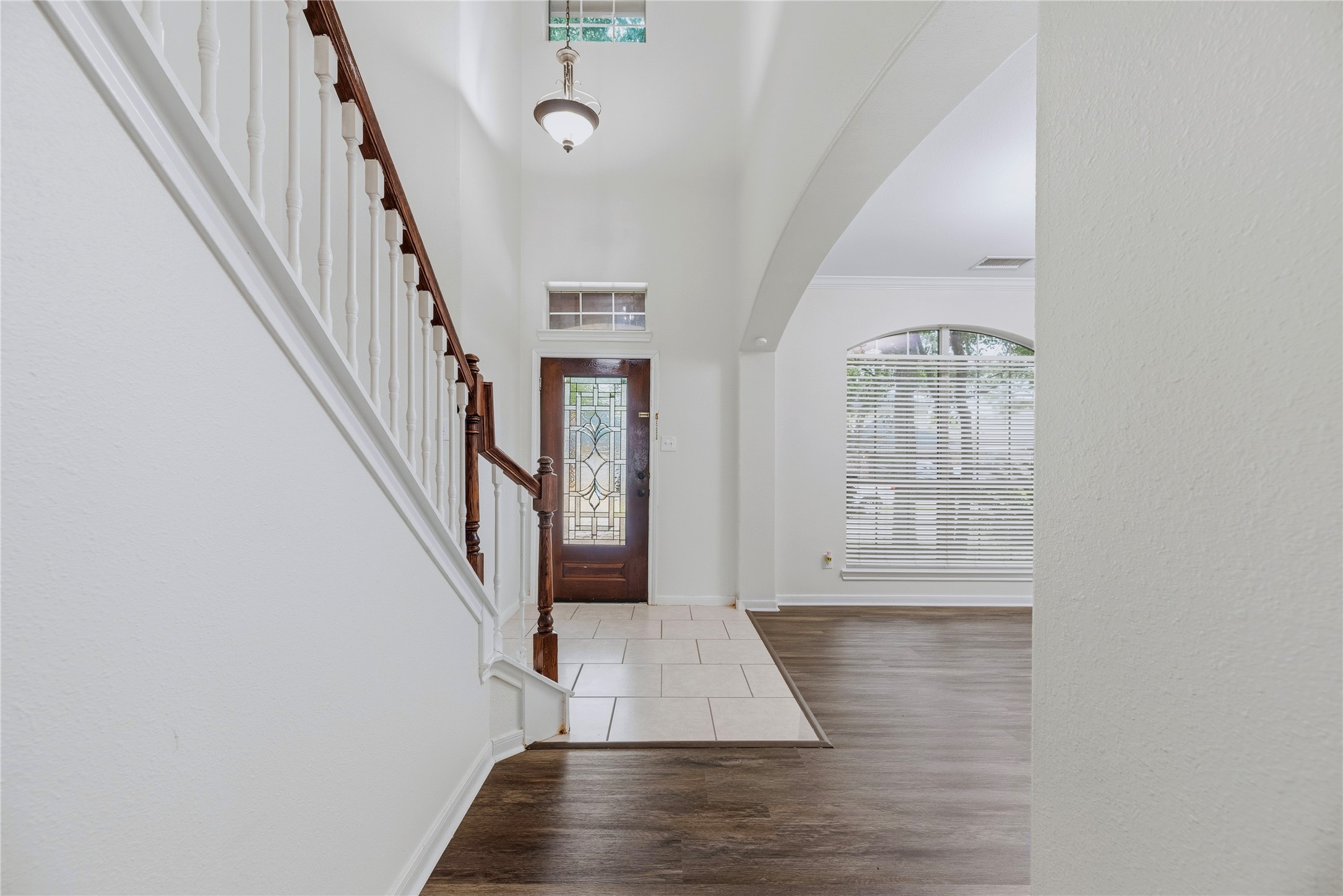 The two-story foyer brings an open feel to the entry, while the front window and decorative-glass door draw daylight into the adjoining spaces. The two-story foyer brings an open feel to the entry, while the front window and decorative-glass door draw daylight into the adjoining spaces.
