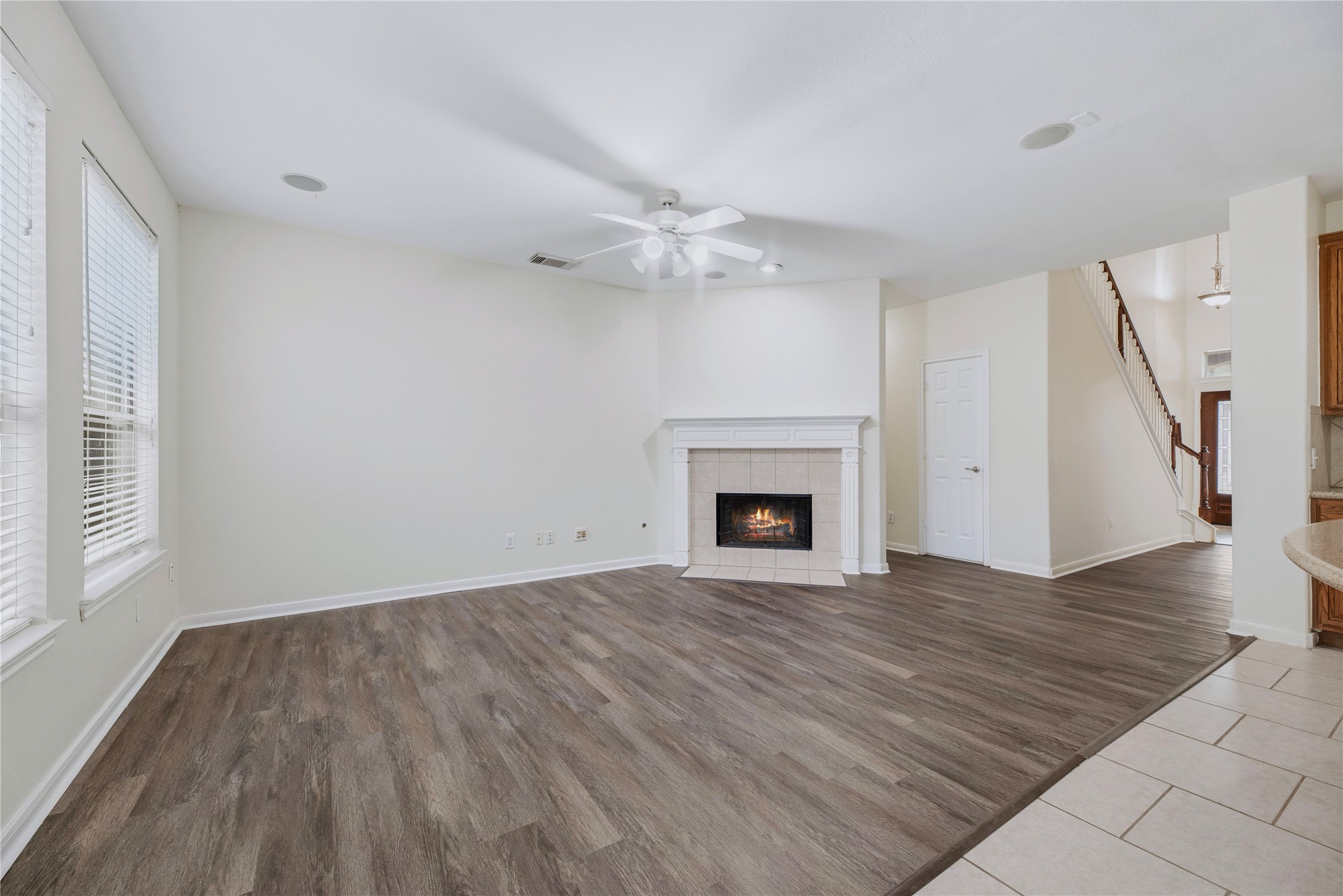 This unfurnished angle reveals the family room floor space and fireplace, making it easier to plan a sofa, media setup and everyday seating.