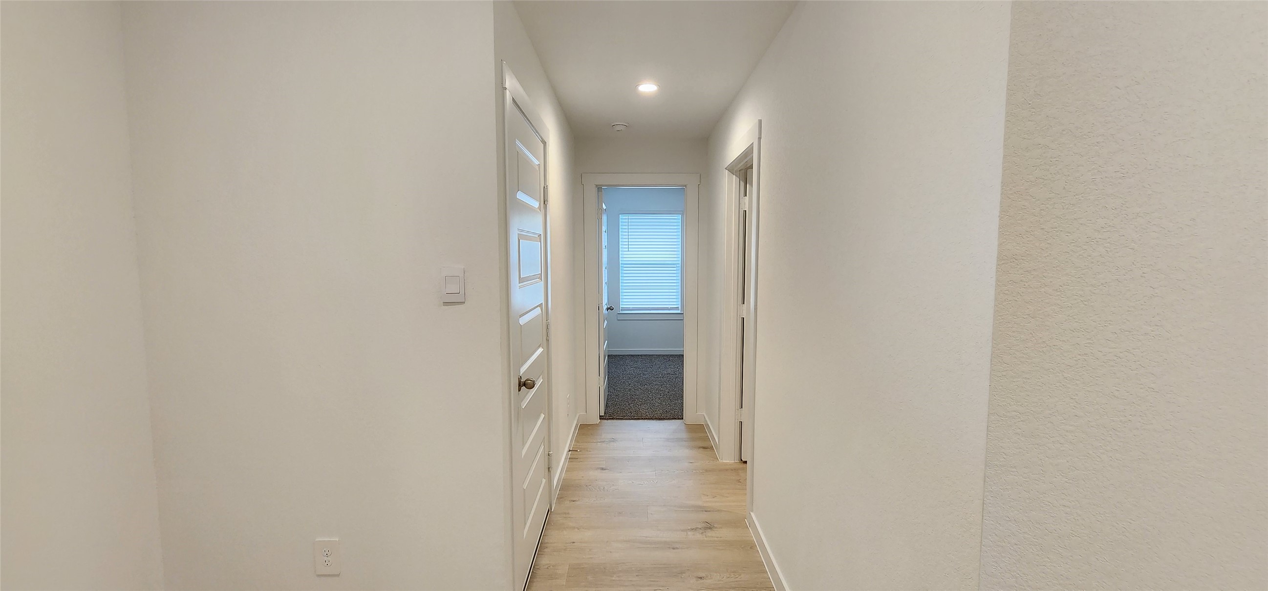Left Hallway to gararge, utility, and bedroom 2