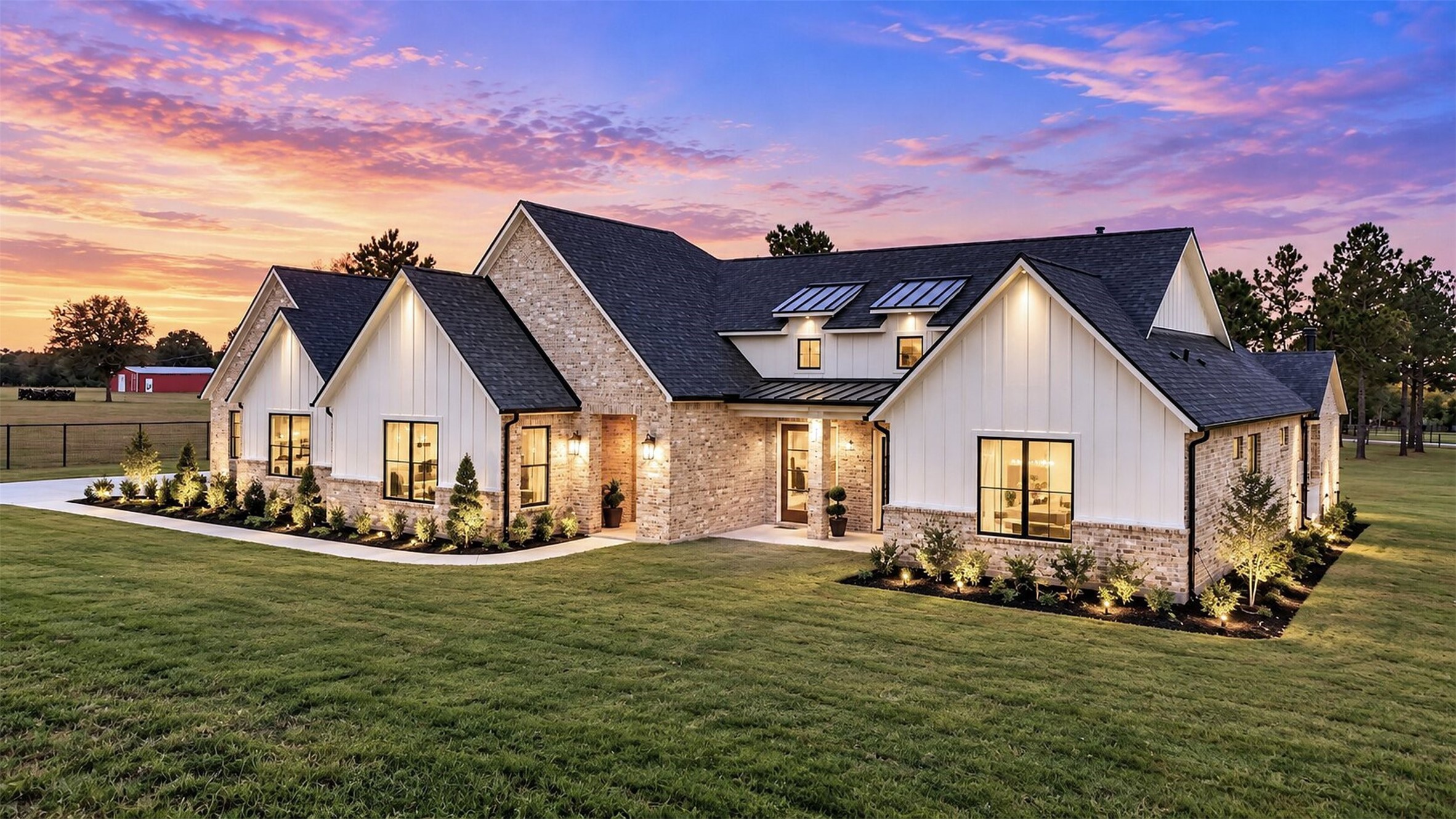 As evening falls, exterior lighting highlights the home's layered rooflines, brick facade, and recessed front entry. As evening falls, exterior lighting highlights the home's layered rooflines, brick facade, and recessed front entry.