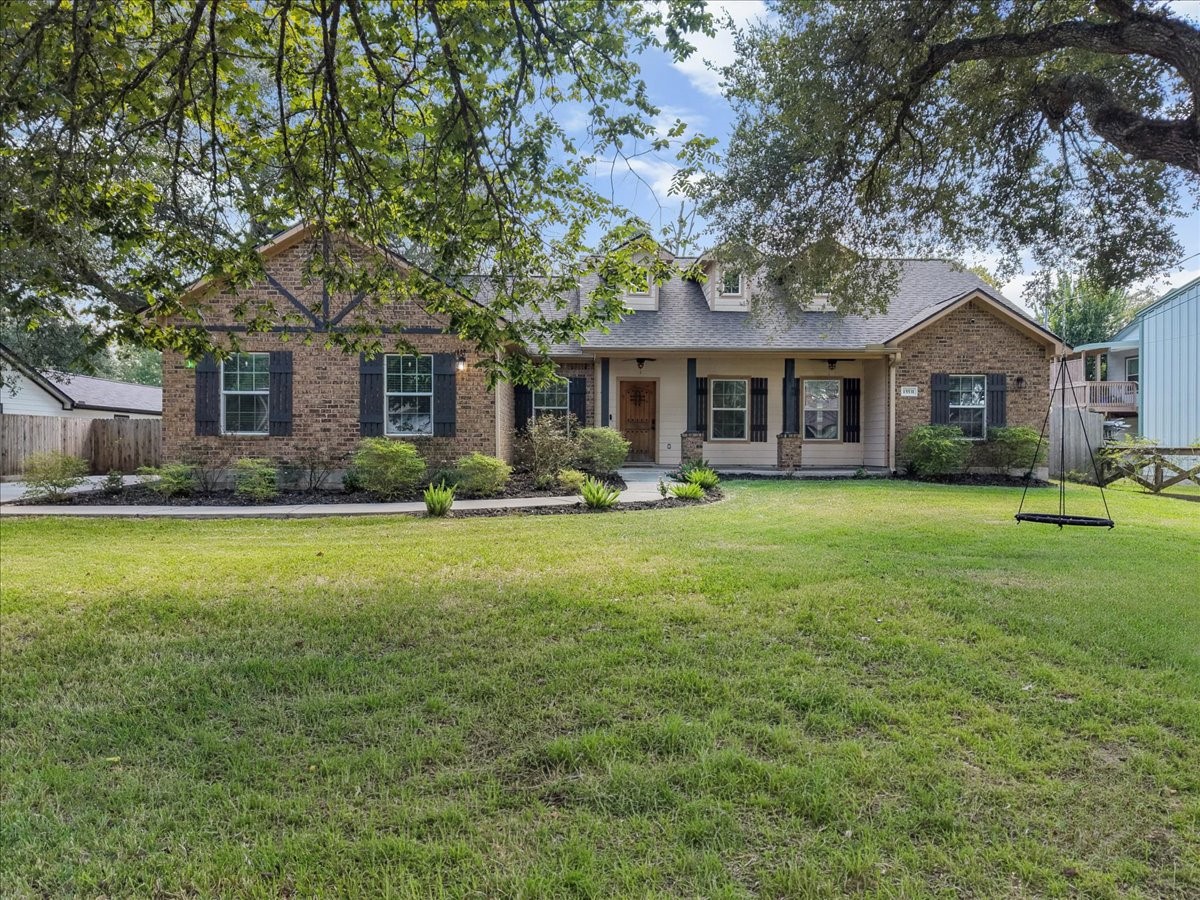 Crisp black shutters and thoughtful landscaping frame a sprawling lawn, perfect for play, pets, or weekend gatherings.