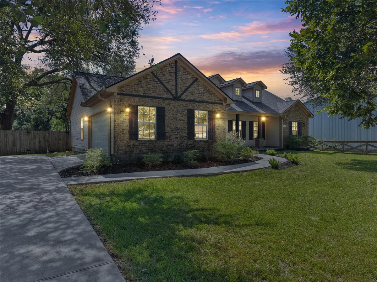 The curved walkway winds through tasteful landscaping toward the front entry.