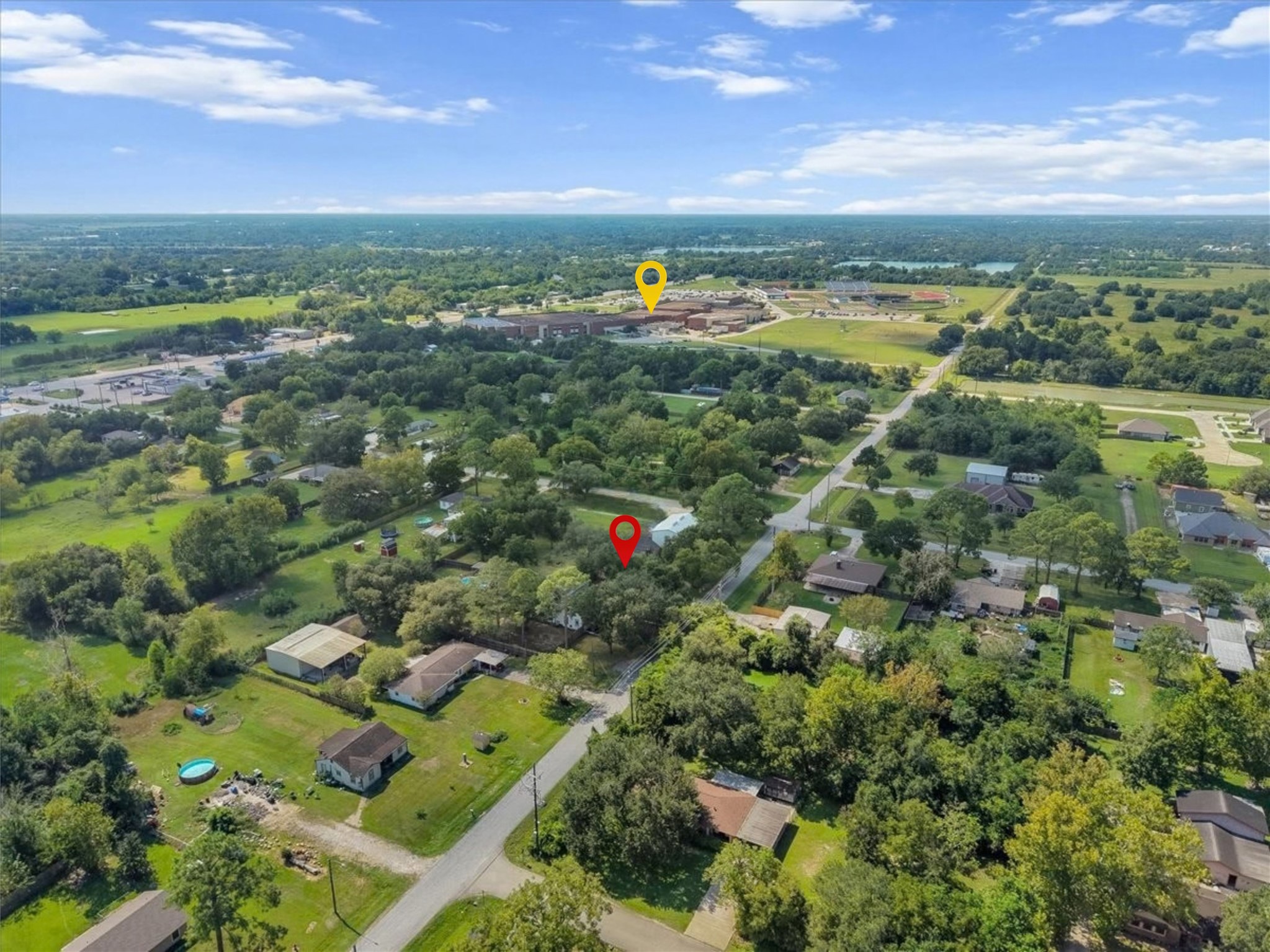This aerial view says it all: mature trees, wide-open green space, and a true neighborhood feel, all just a short walk from Santa Fe High School (yellow pin) and its athletic fields.