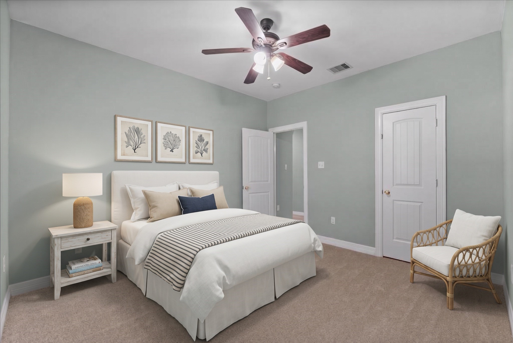 This bedroom features new carpet, a ceiling fan, and a reach-in closet. Soft neutral paint and ample wall space give the room flexibility for any furniture layout.
