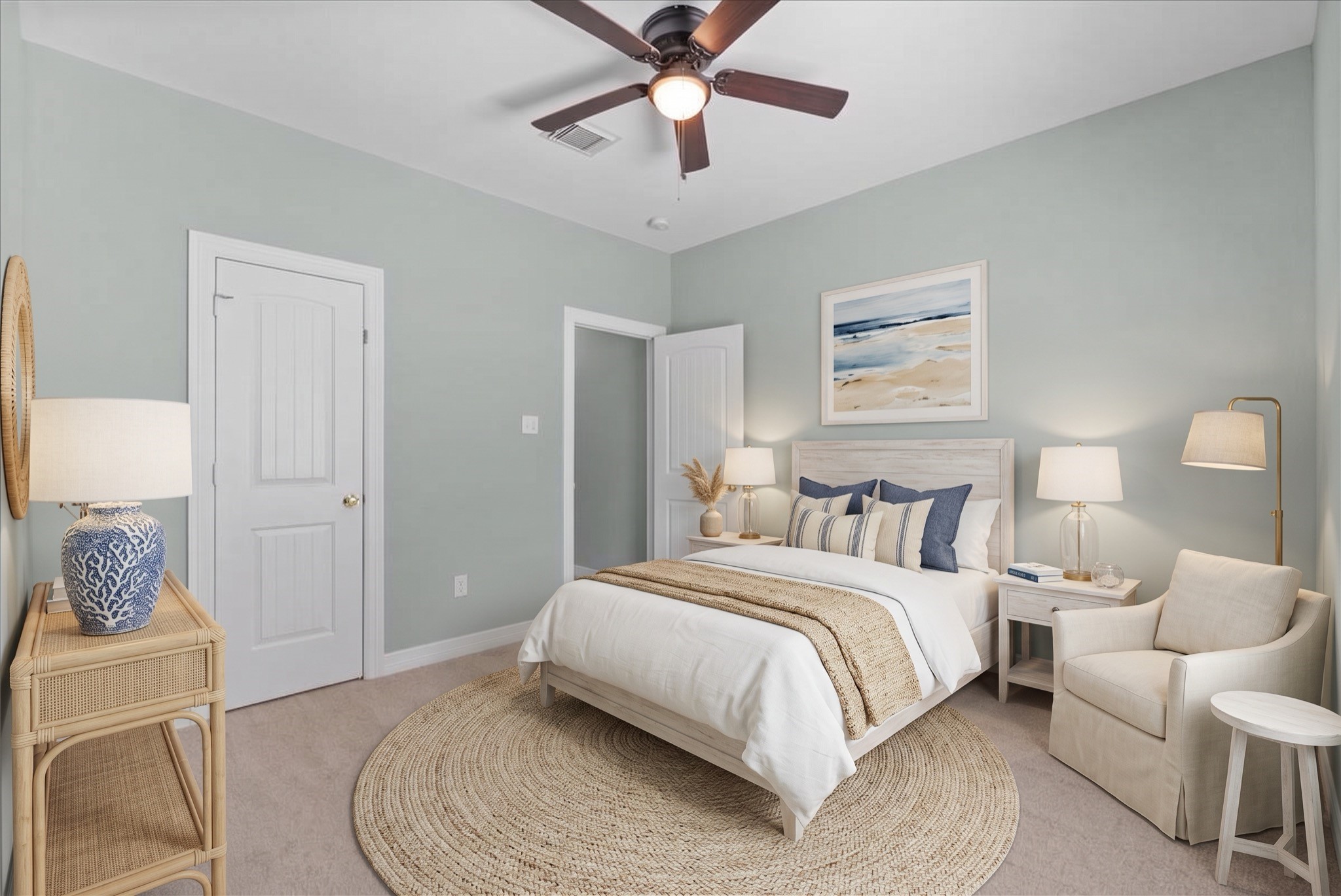 This room features new carpet, a ceiling fan, and a walk-in closet, with a second door offering additional storage or access. Soft neutral paint and generous natural light give the space a bright, airy feel.