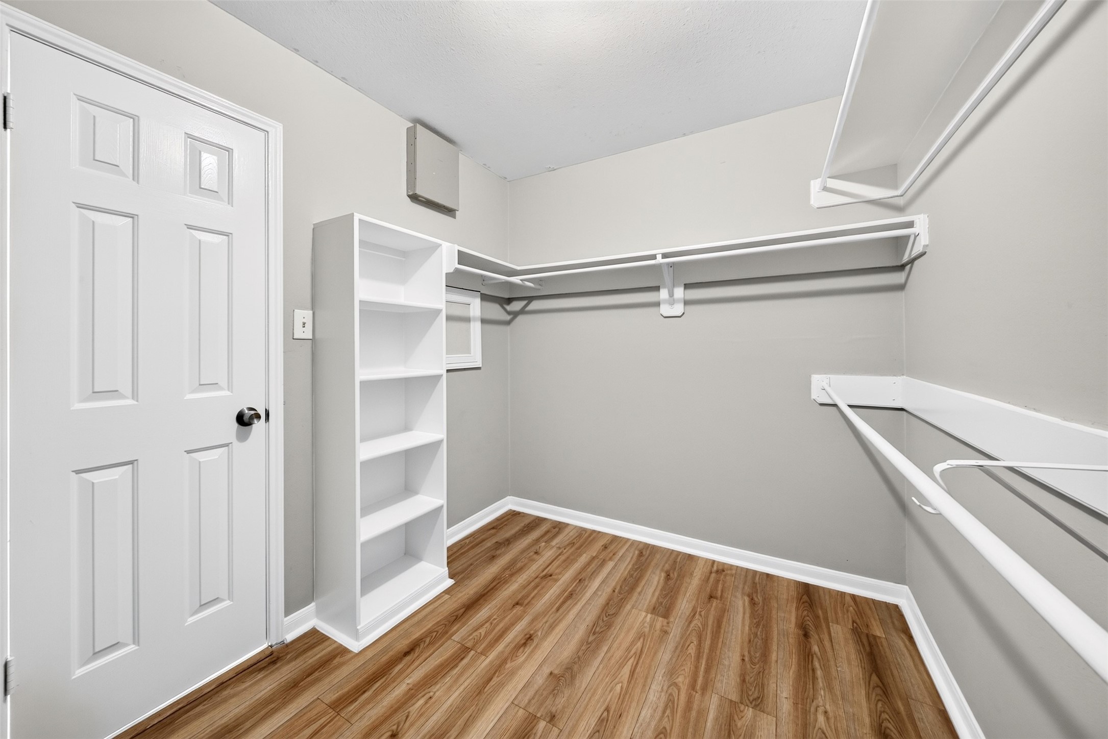 Walk-In Closet

Generously sized walk-in closet featuring built-in shelving, multiple hanging areas and attractive wood-look flooring, providing ample space for organized storage.