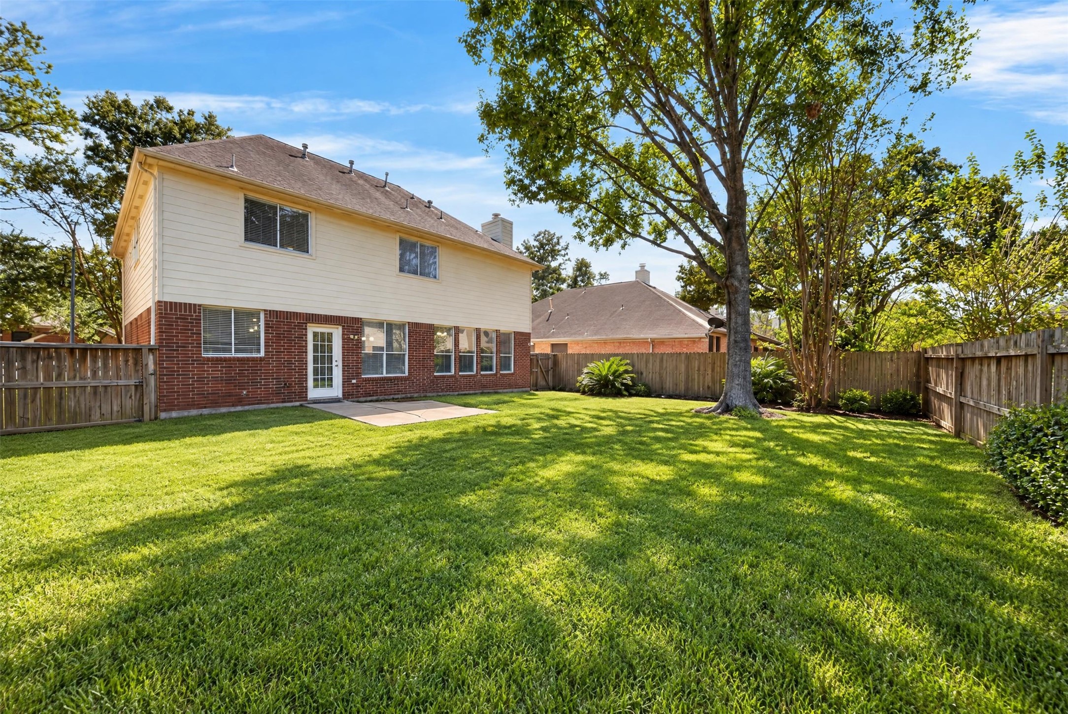 Backyard: Spacious fenced backyard with mature shade trees, lush lawn and patio space offers an inviting setting for outdoor living and entertaining.