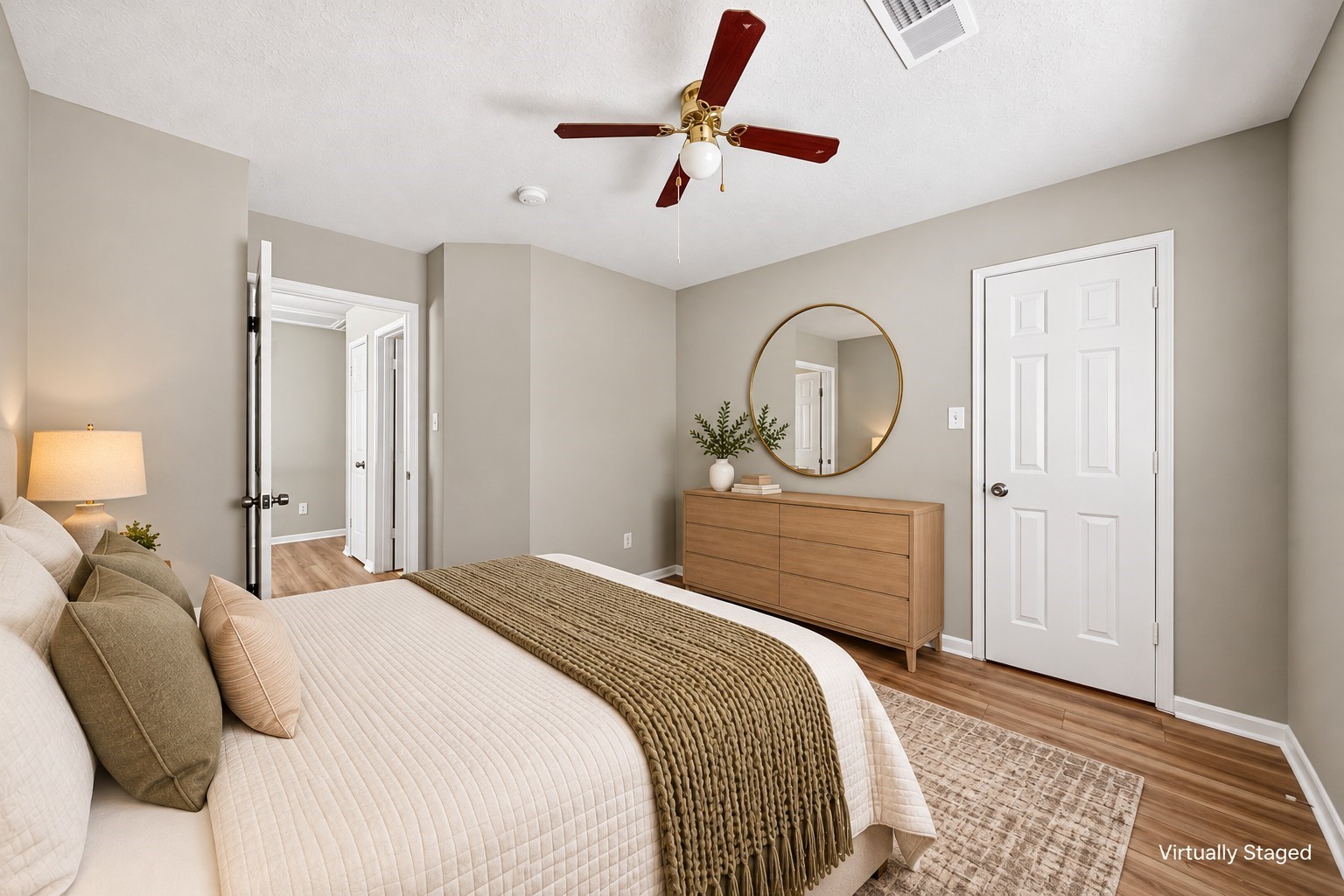 Secondary Bedroom: Comfortable secondary bedroom with wood-look flooring, ceiling fan, closet access and flexible space for furnishings.