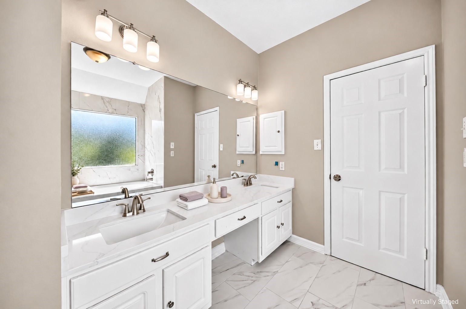 Primary Bathroom Vanity: Elegant double-sink vanity showcases a generous countertop, expansive mirror, modern fixtures and ample cabinetry for storage.