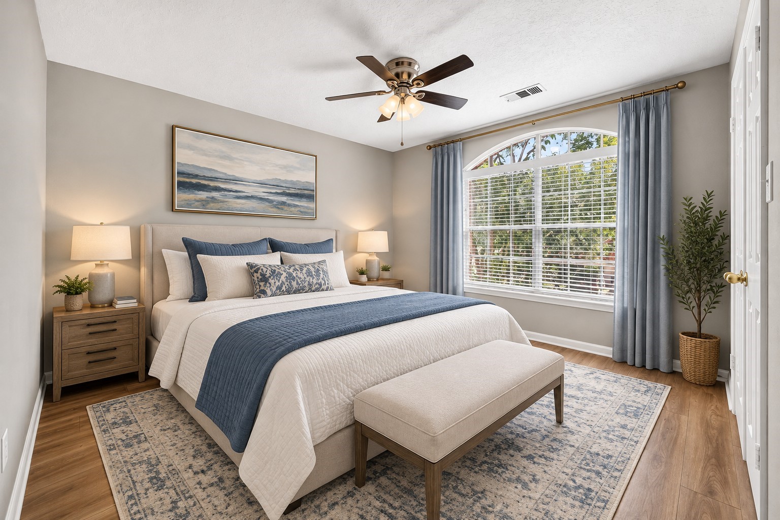 Secondary Bedroom  Alternate View: An inviting secondary bedroom highlighted by a beautiful arched window, abundant natural light and warm wood-look floors.