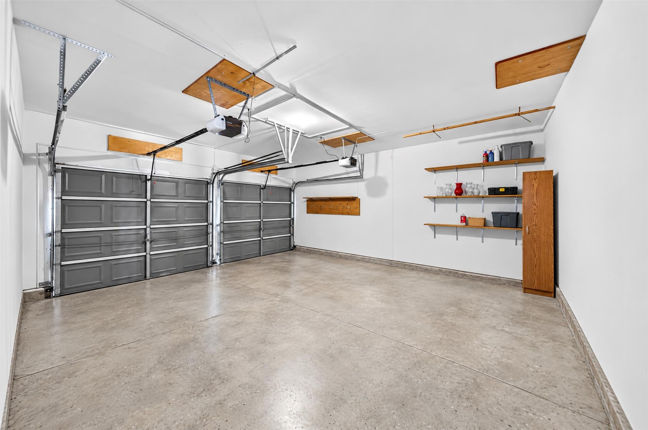 Attached Two-Car Garage

Spacious attached two-car garage features dual garage doors with automatic openers, built-in wall shelving and additional storage space for everyday convenience.