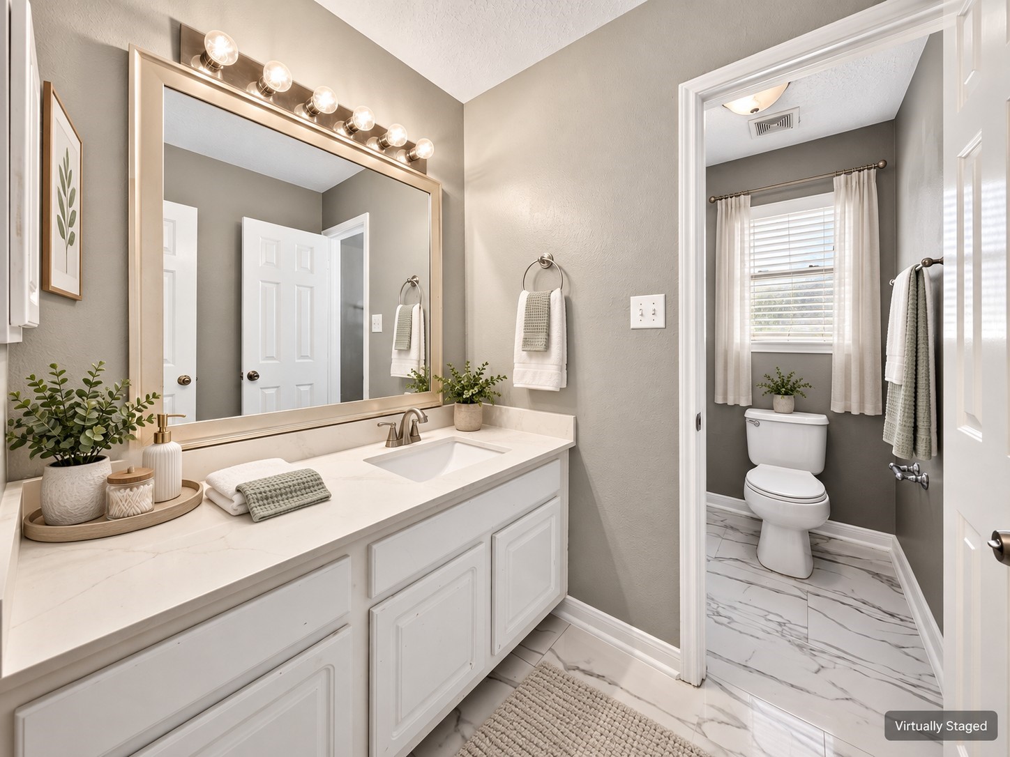 Secondary Bathroom Vanity: Bright vanity area features white cabinetry, generous counter space and an expansive mirror, complementing the adjoining bathroom.