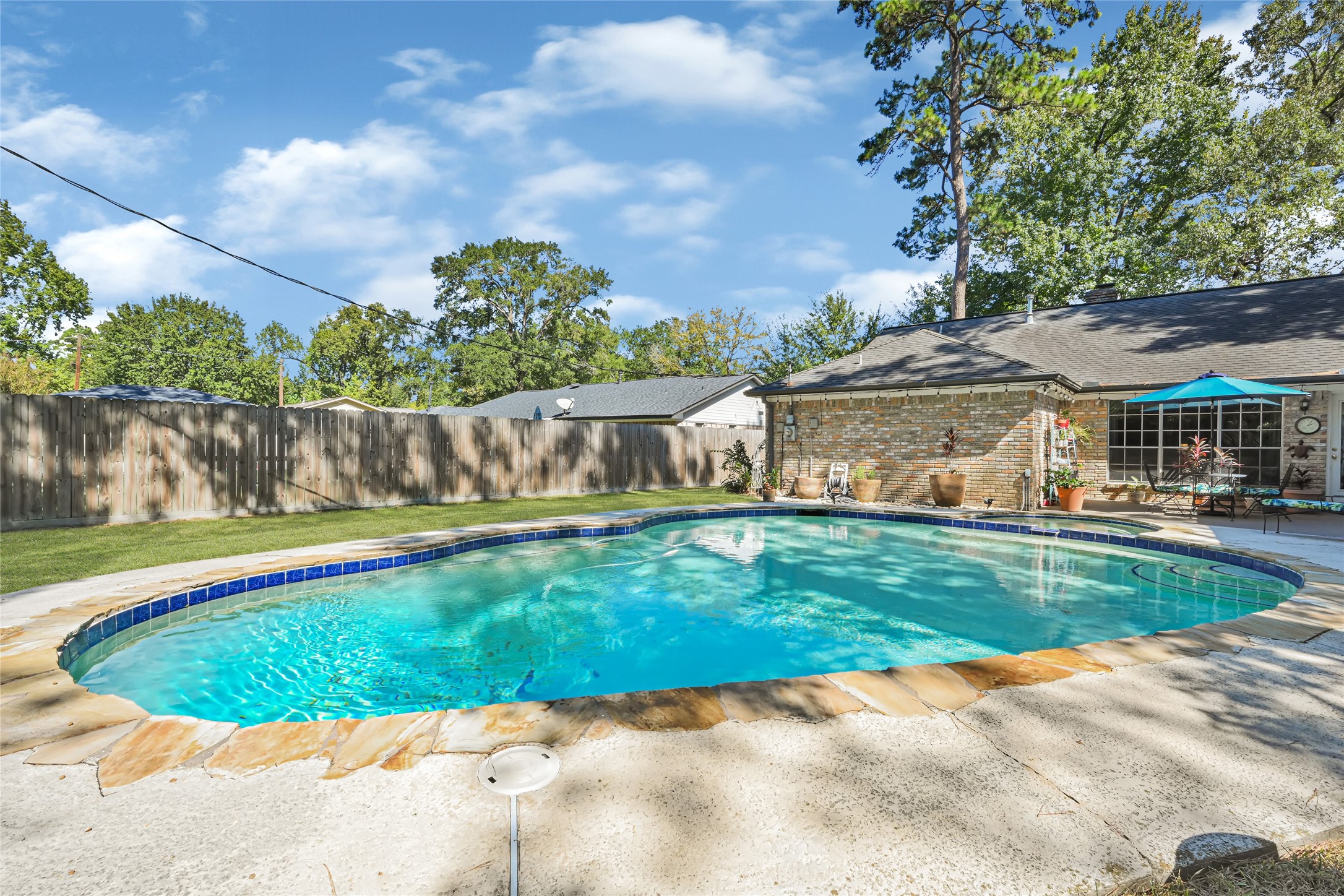 Charming backyard oasis featuring a sparkling pool surrounded by a spacious patio, perfect for relaxation and entertaining. Charming backyard oasis featuring a sparkling pool surrounded by a spacious patio, perfect for relaxation and entertaining.
