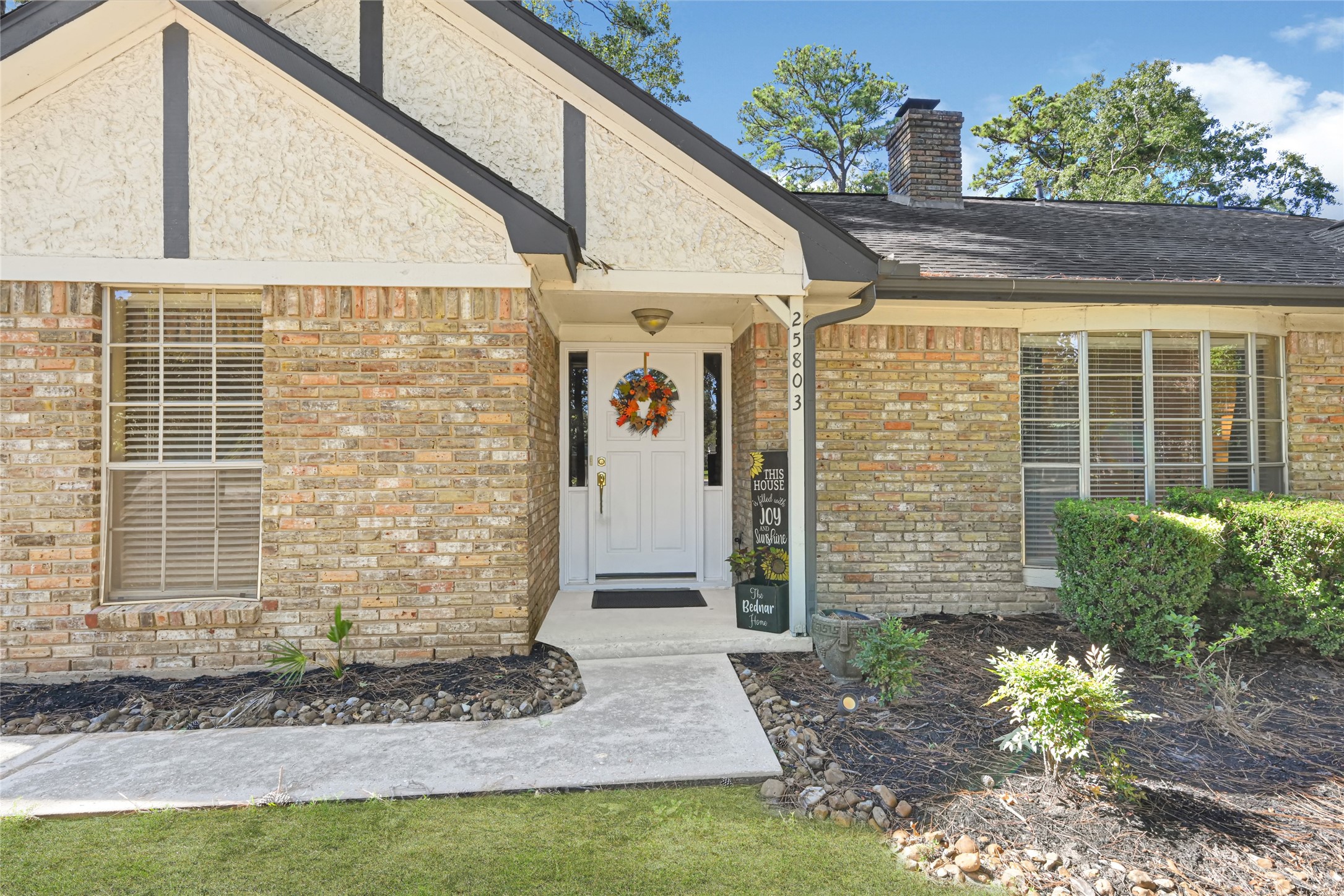 Charming brick home with a welcoming front porch, accented by a bright white door and lush greenery, offering great curb appeal. Charming brick home with a welcoming front porch, accented by a bright white door and lush greenery, offering great curb appeal.
