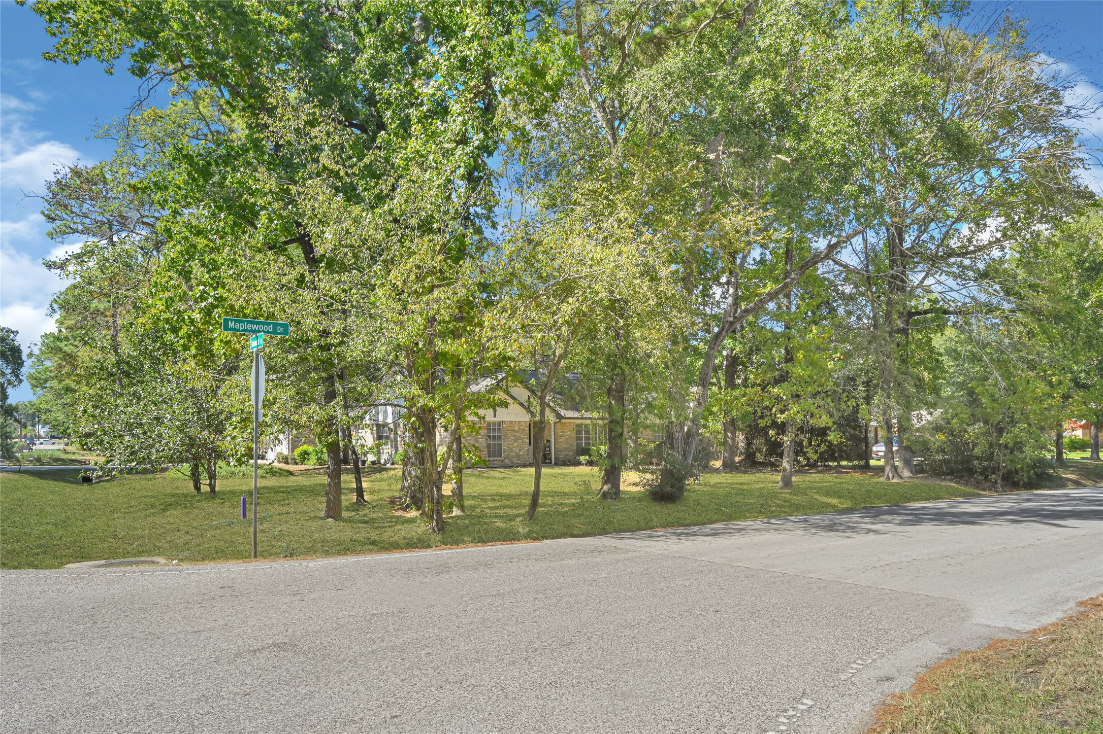 Charming home nestled on a spacious corner lot, surrounded by mature trees offering ample shade and privacy.