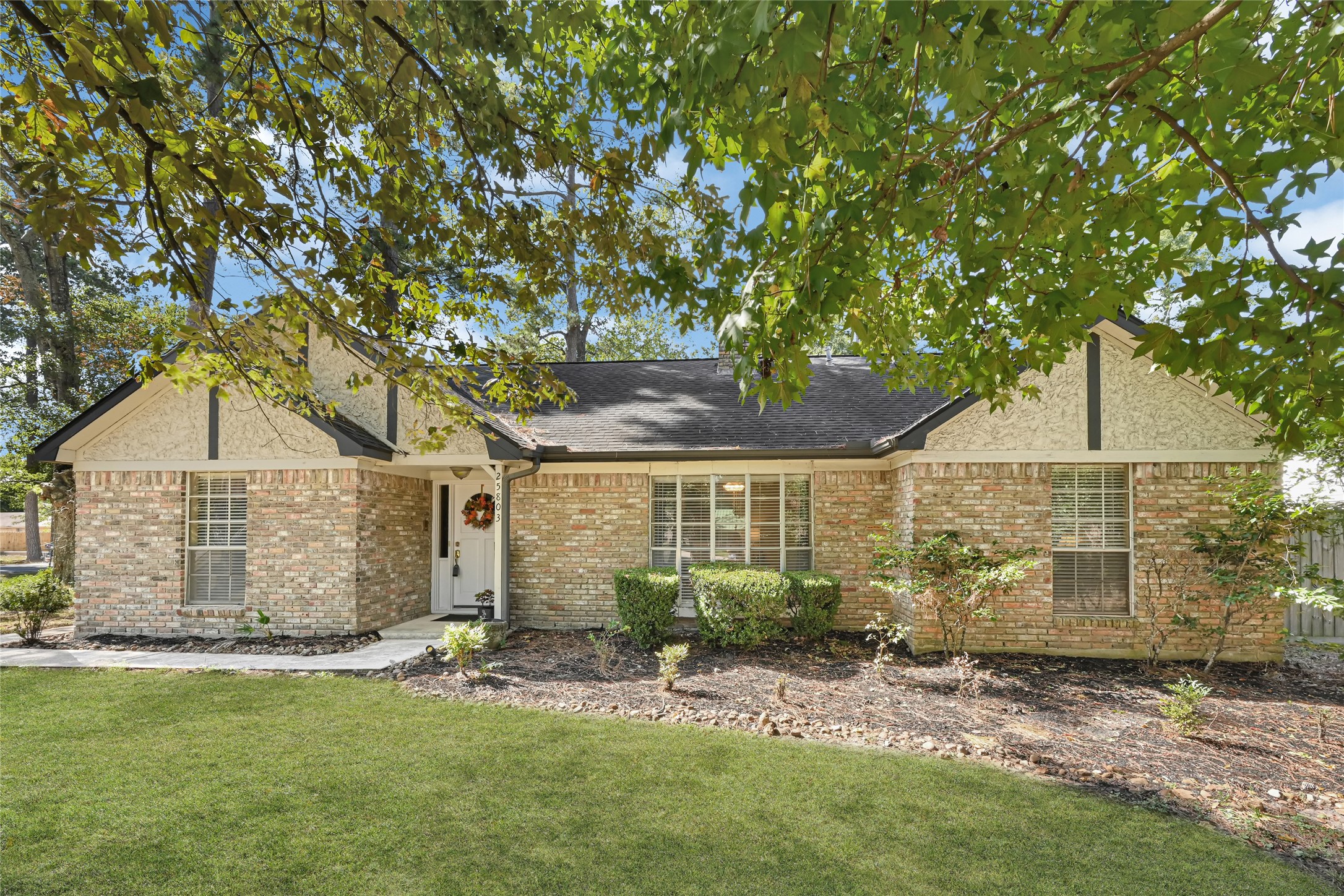 Charming brick home with a welcoming front porch, lush landscaping, and mature trees providing ample shade. Charming brick home with a welcoming front porch, lush landscaping, and mature trees providing ample shade.