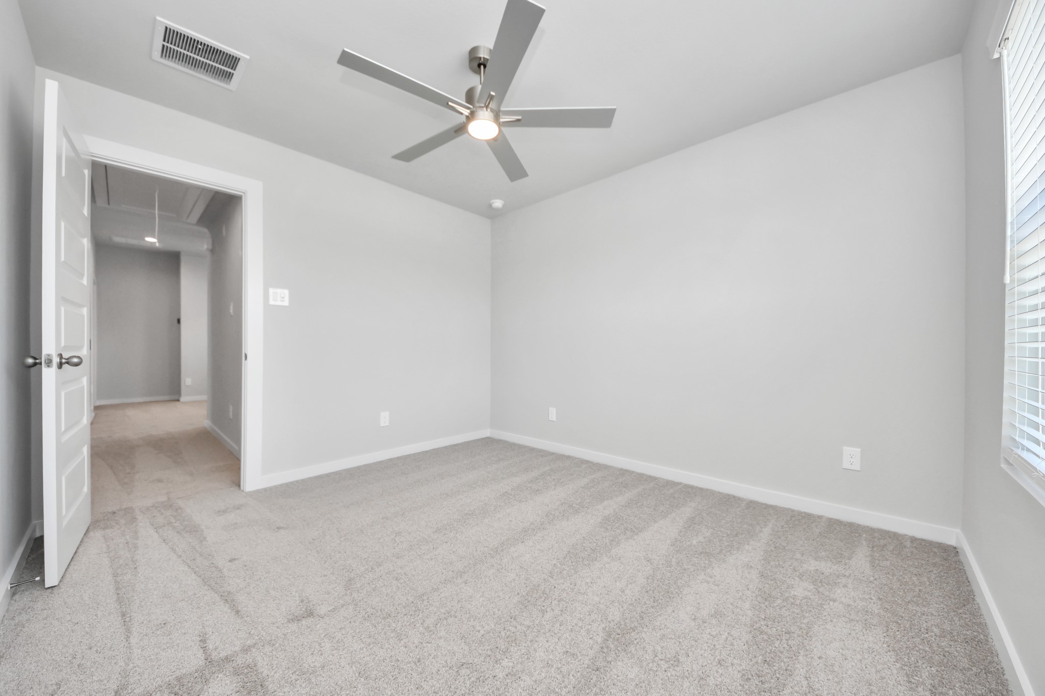 Generously sized secondary bedrooms featuring spacious closets, soft and inviting carpeting underfoot, large windows allowing plenty of natural light, and the added touch of privacy blinds for your personal retreat. Sample photo of completed home with similar floor plan. Actual colors and selections may vary.