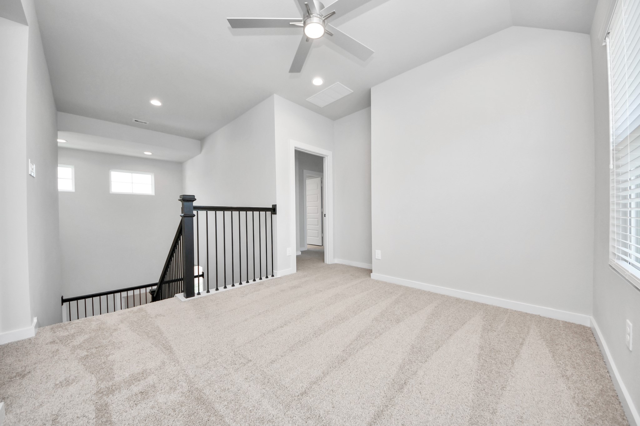 Come upstairs and enjoy a day of leisure in this fabulous game room! This is the perfect hangout spot or adult game room! Features plush carpet, high ceilings, custom paint and windows for plenty of natural light. Sample photo of completed home with similar floor plan. Actual colors and selections may vary.