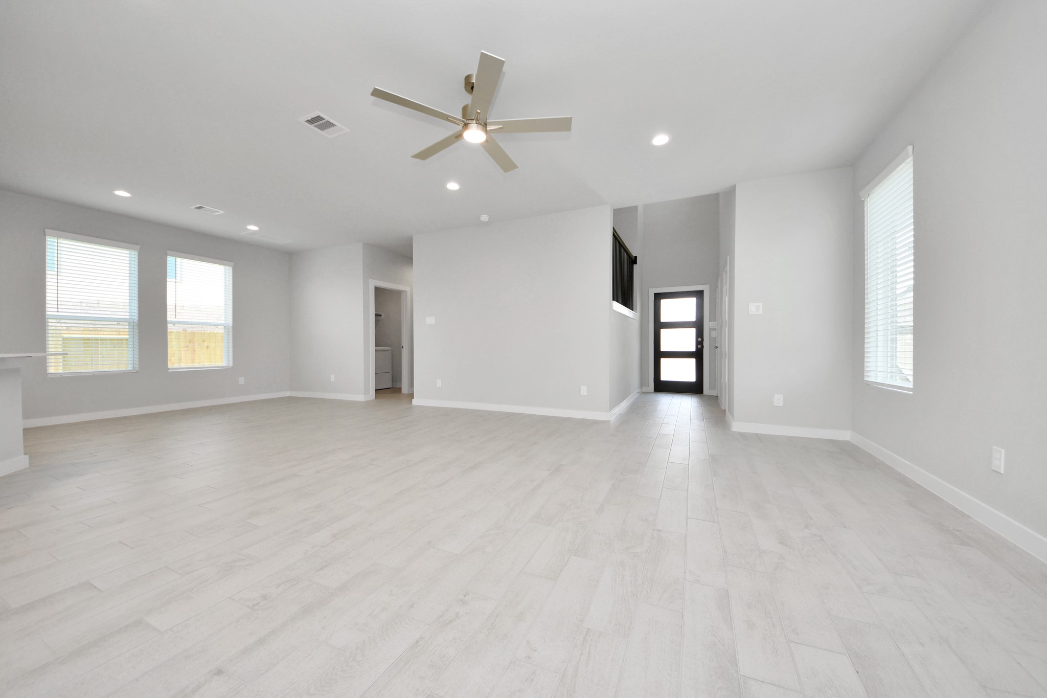 Gather the family and guests together in your lovely living room! Featuring soaring high ceilings, recessed lighting, ceiling fan, custom paint, gorgeous floors, and large windows that provide plenty of natural lighting throughout the day. Sample photo of completed home with similar floor plan. Actual colors and selections may vary.