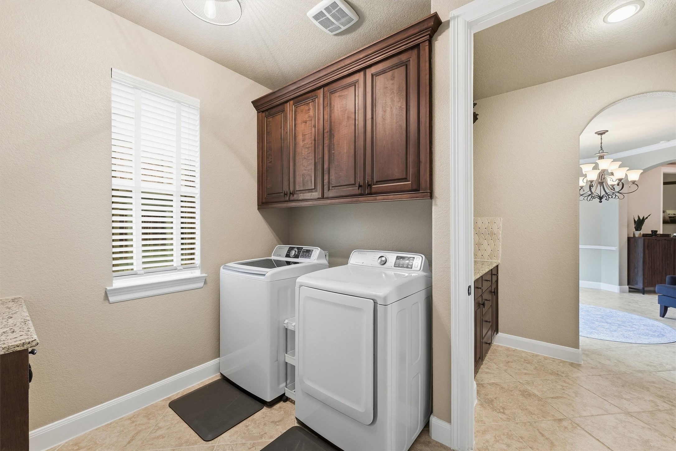 Convenient utility room with extra storage and access to the primary bathroom/closet