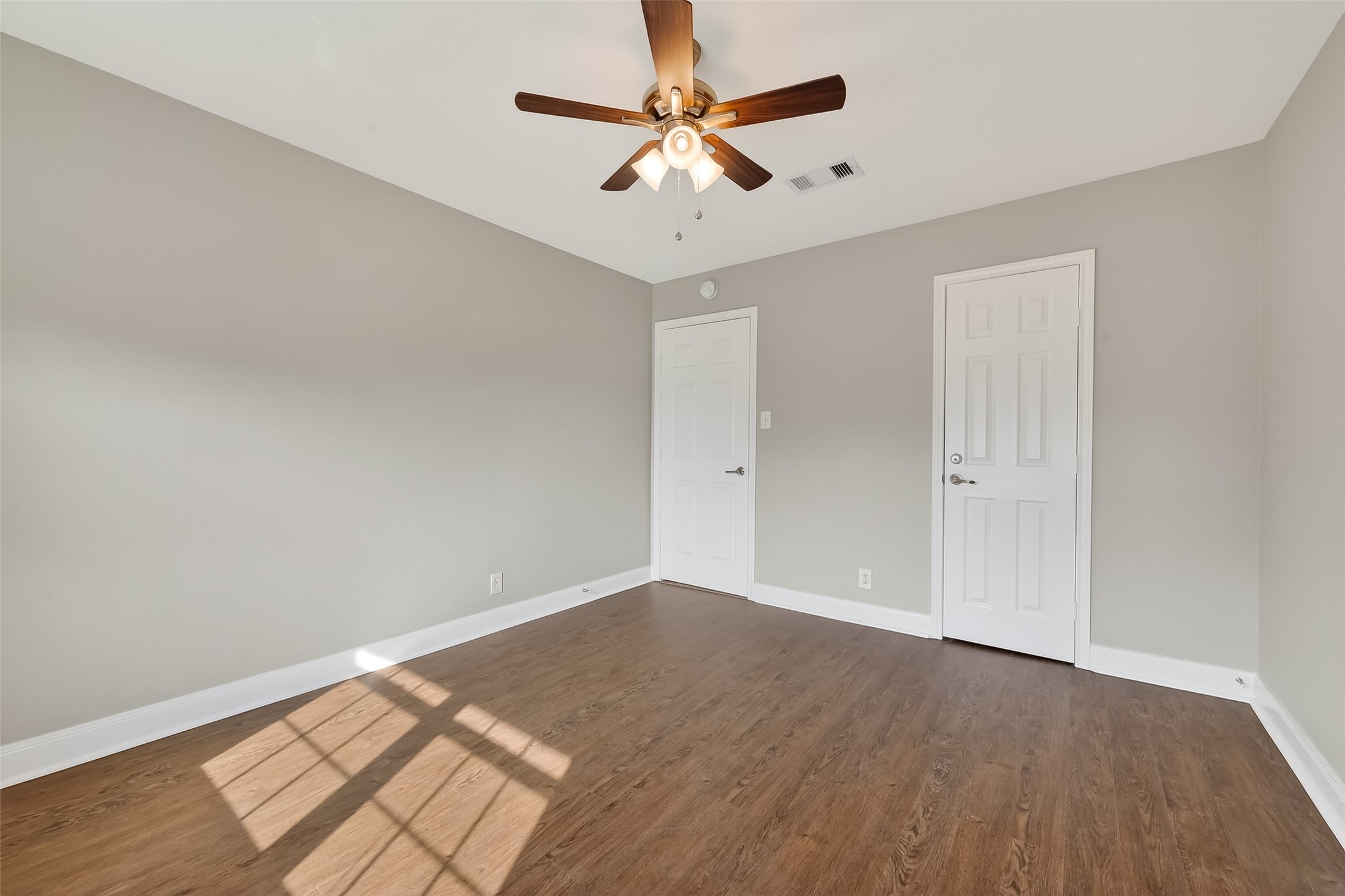 Spacious guest bedroom with natural light and updated finishes in this Houston townhome near the Galleria.