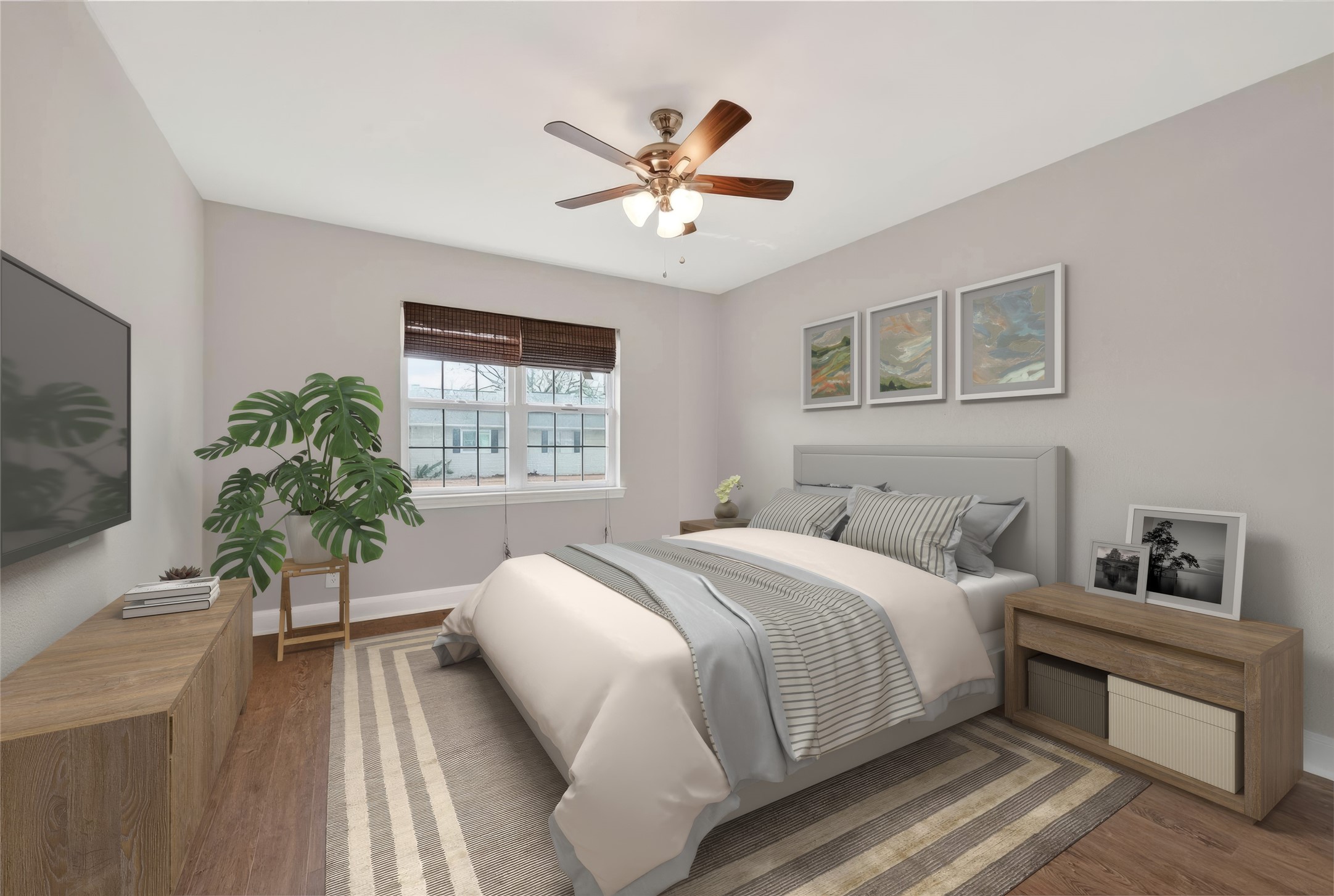 Bright secondary bedroom with updated flooring and flexible space for guests, office, or additional living needs.