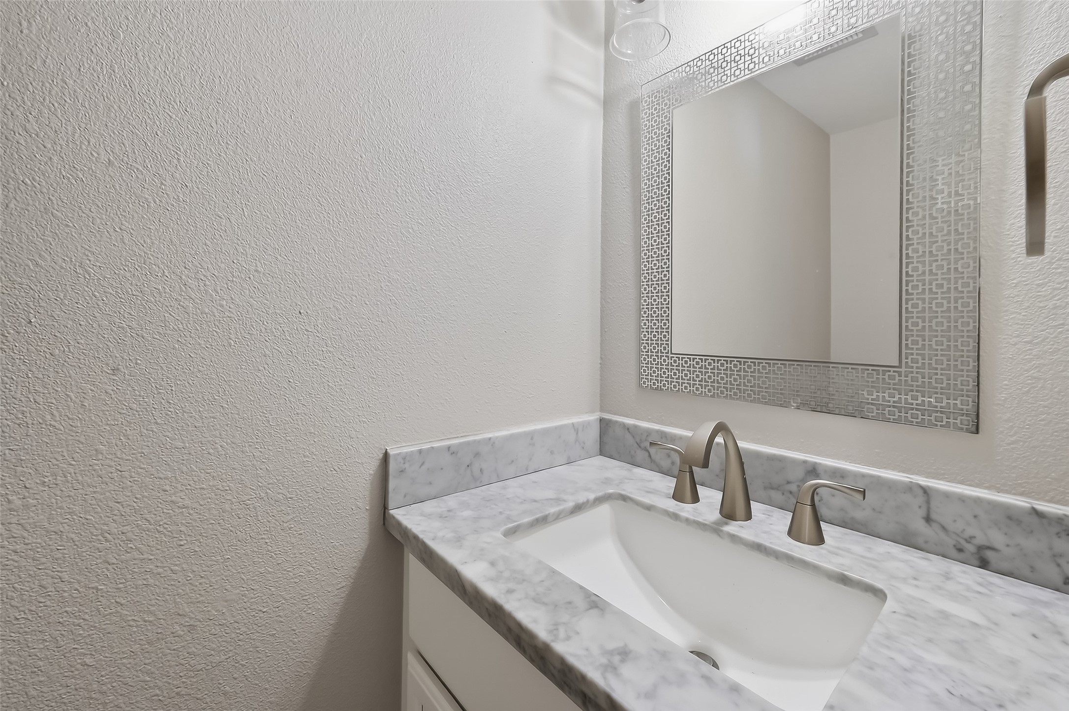 Convenient first-floor powder bath with updated finishes and modern design details.